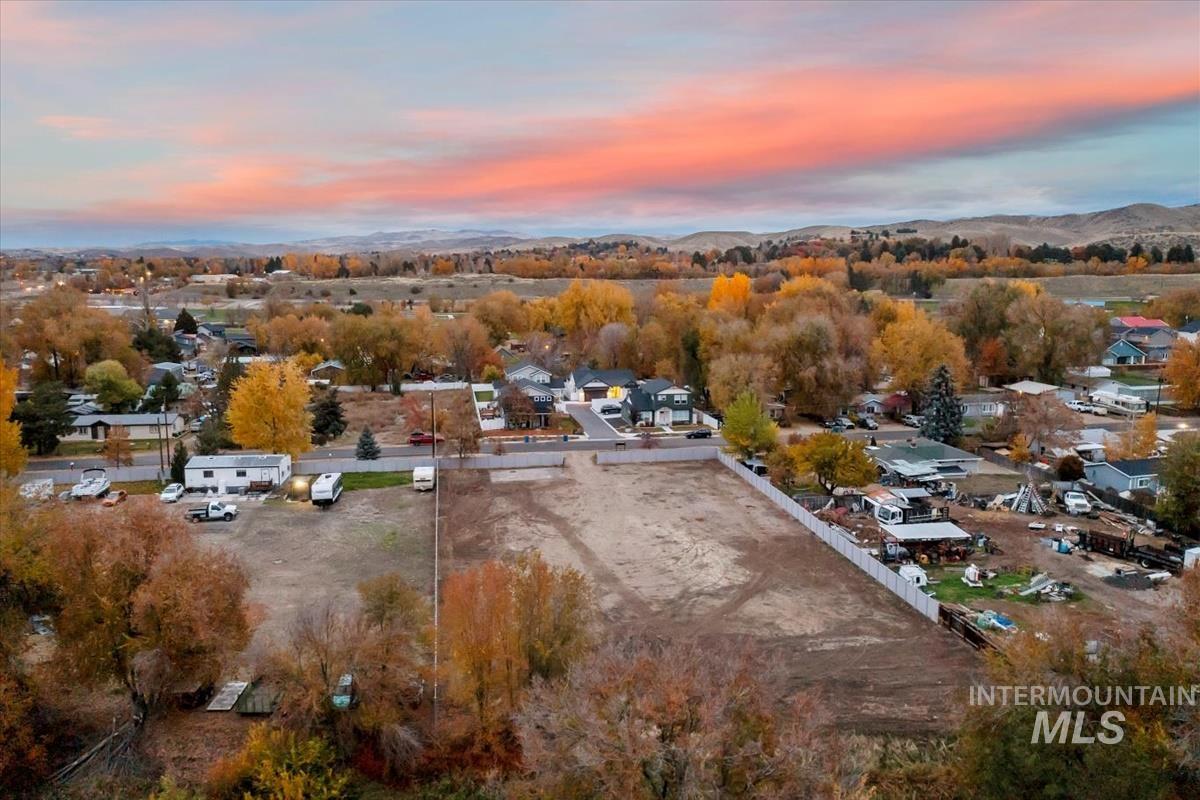 Aerial view at dusk of view of wooded area and a residential view
