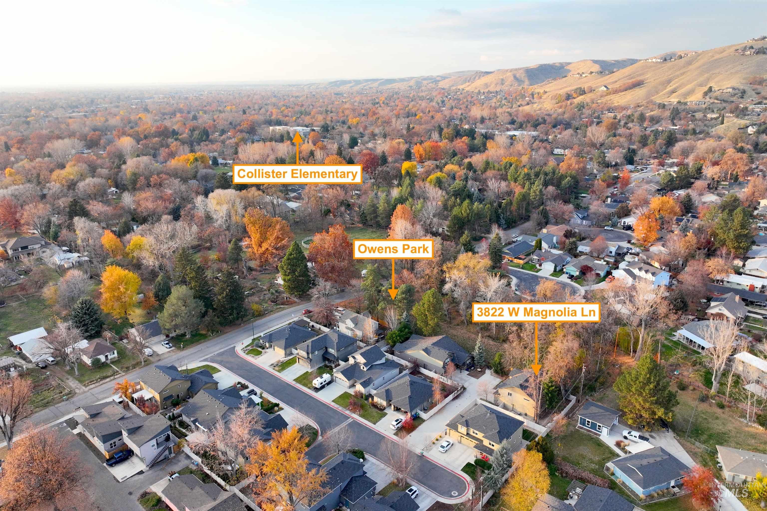 Aerial view of property and surrounding area featuring nearby suburban area
