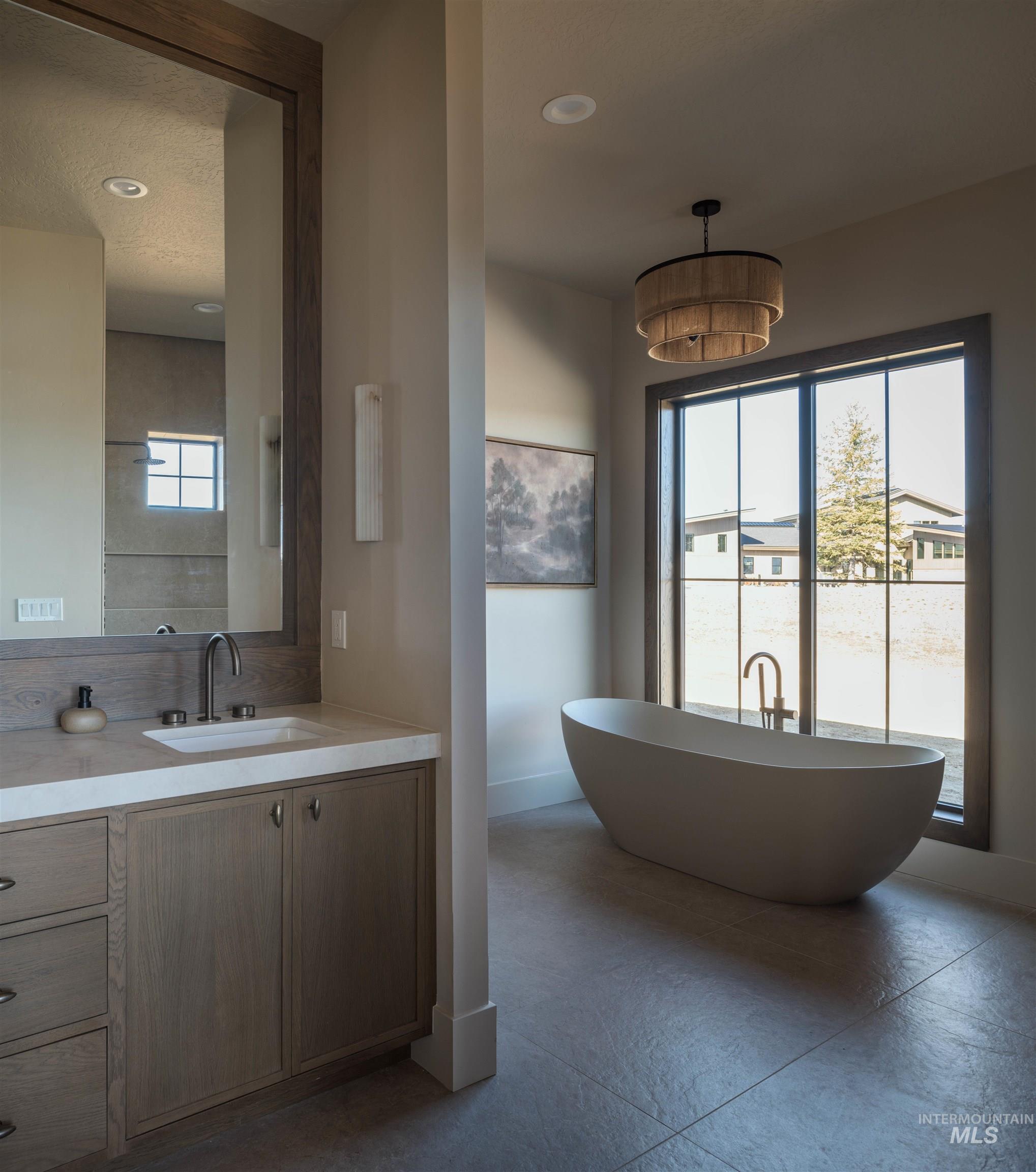Primary Bathroom featuring a soaking tub, vanity, and recessed lighting