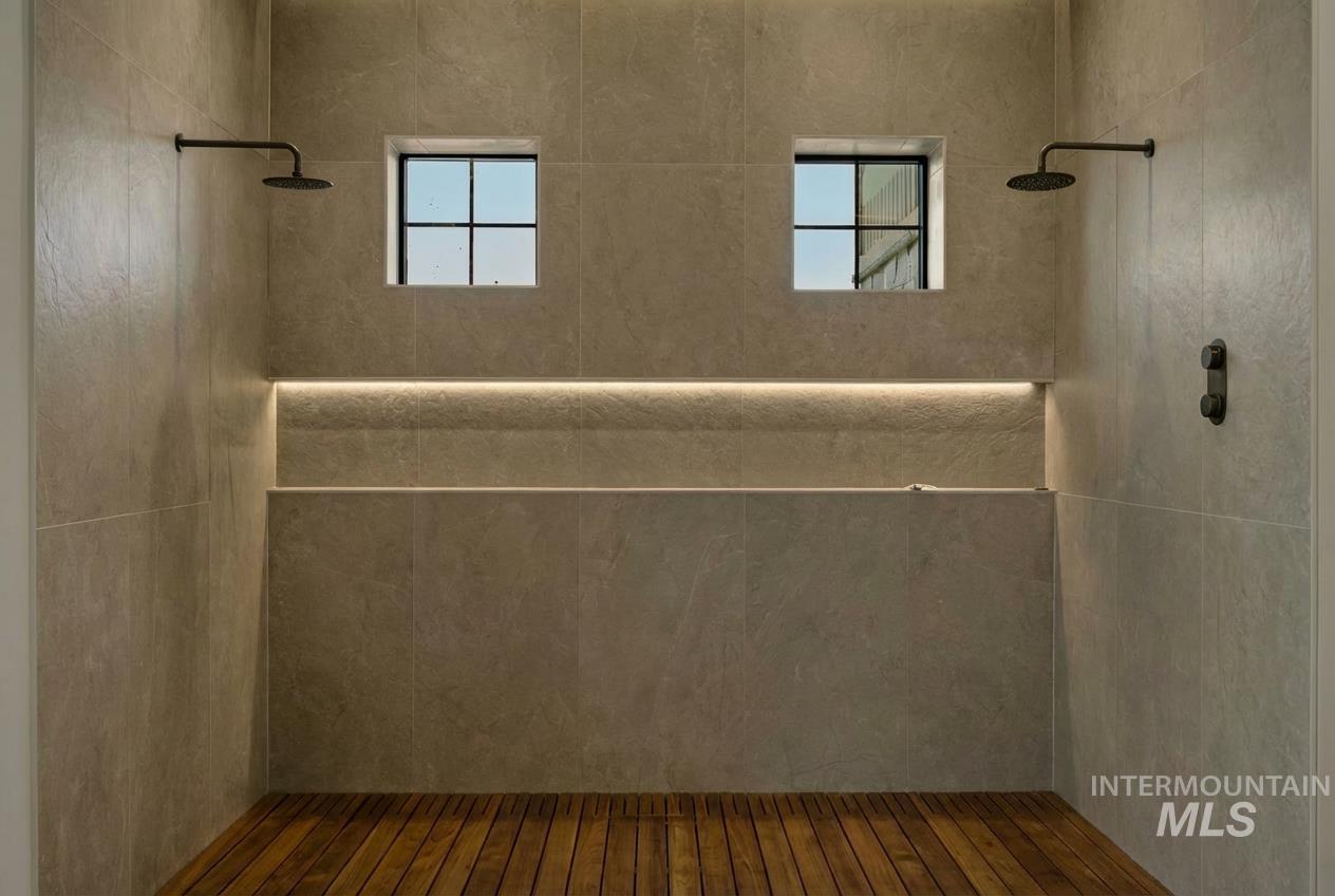 Primary Bathroom featuring a walk in shower and healthy amount of natural light with Teak Wood Flooring