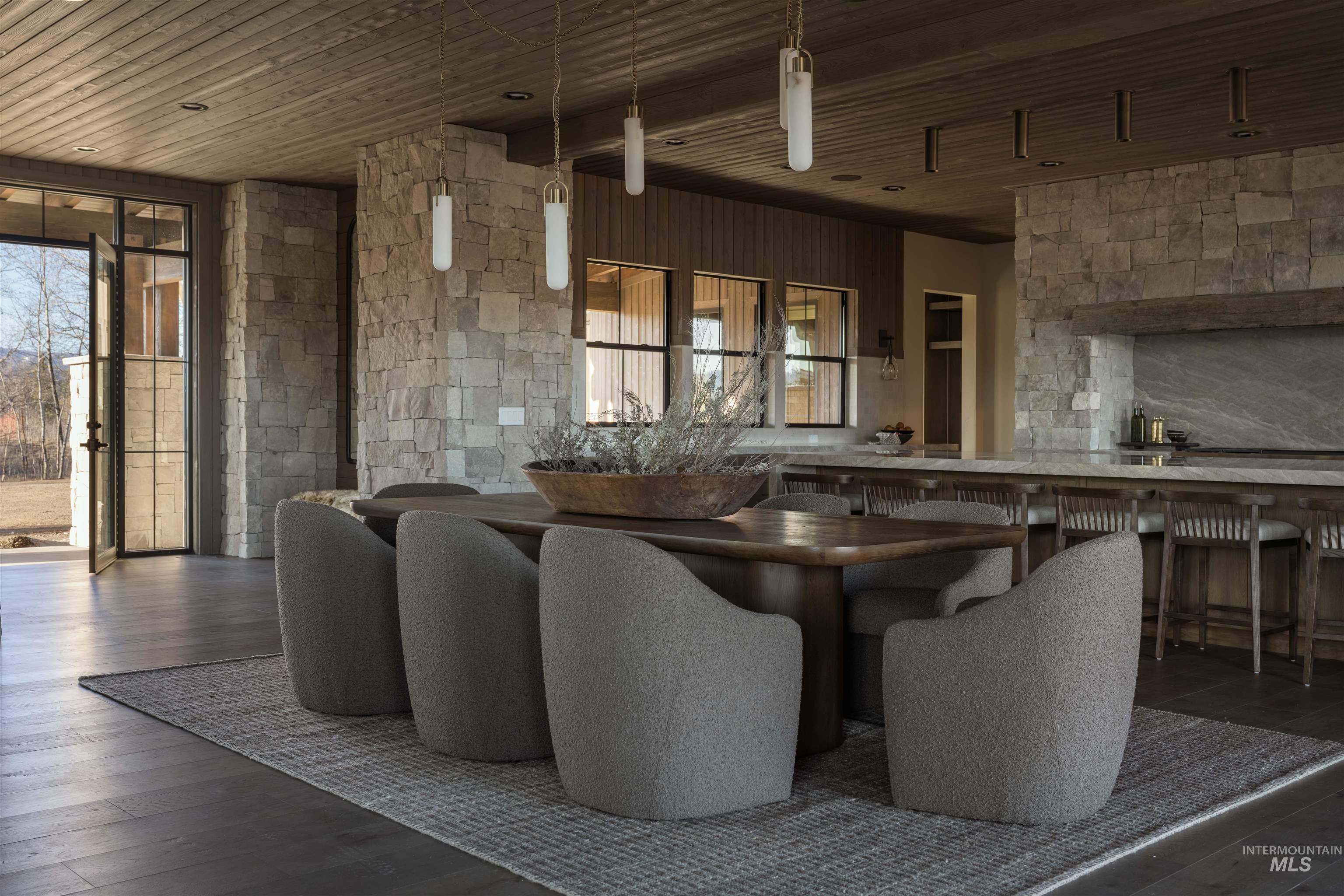 Dining space with dark wood-style flooring and wooden ceiling