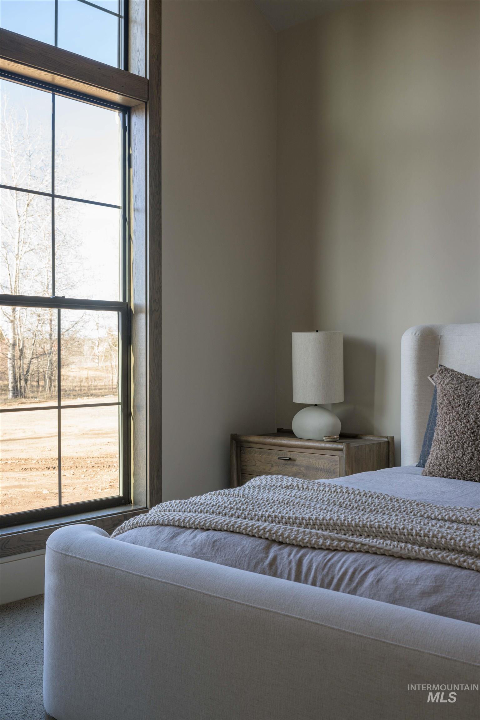 Jr Suite Bedroom featuring multiple windows - Main floor