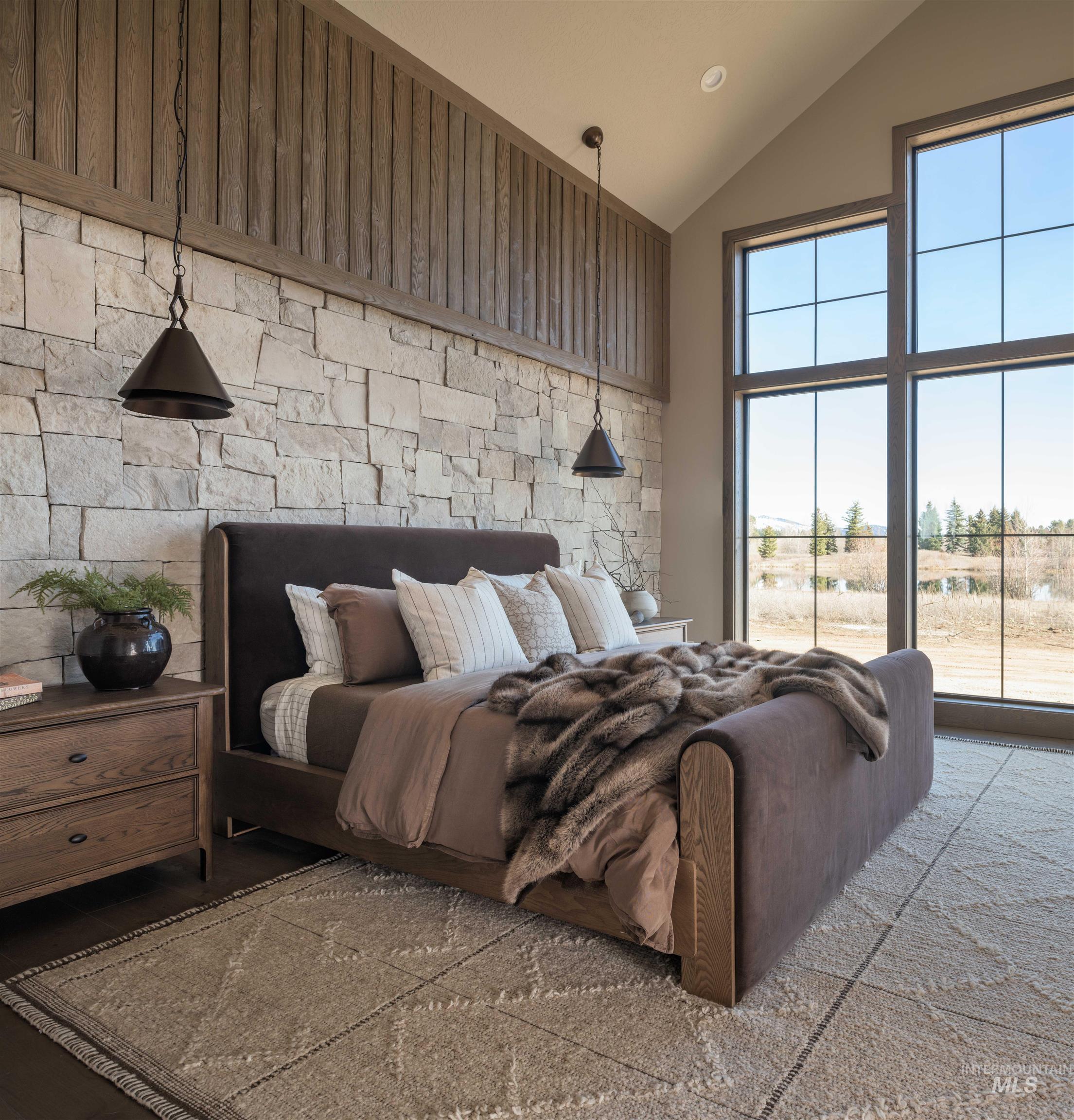 Primary Bedroom featuring lofted ceiling and access to outside, propane fire place and en suite