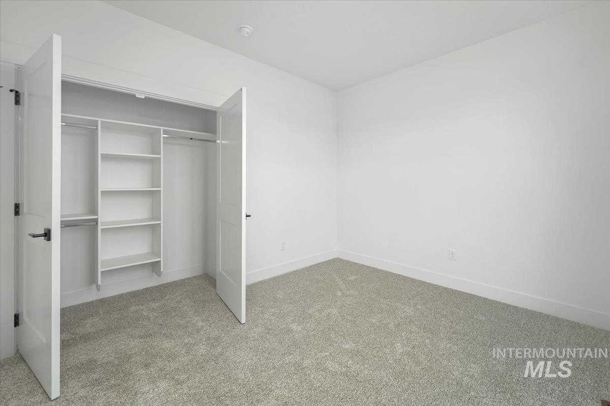 Unfurnished bedroom with carpet flooring and a closet