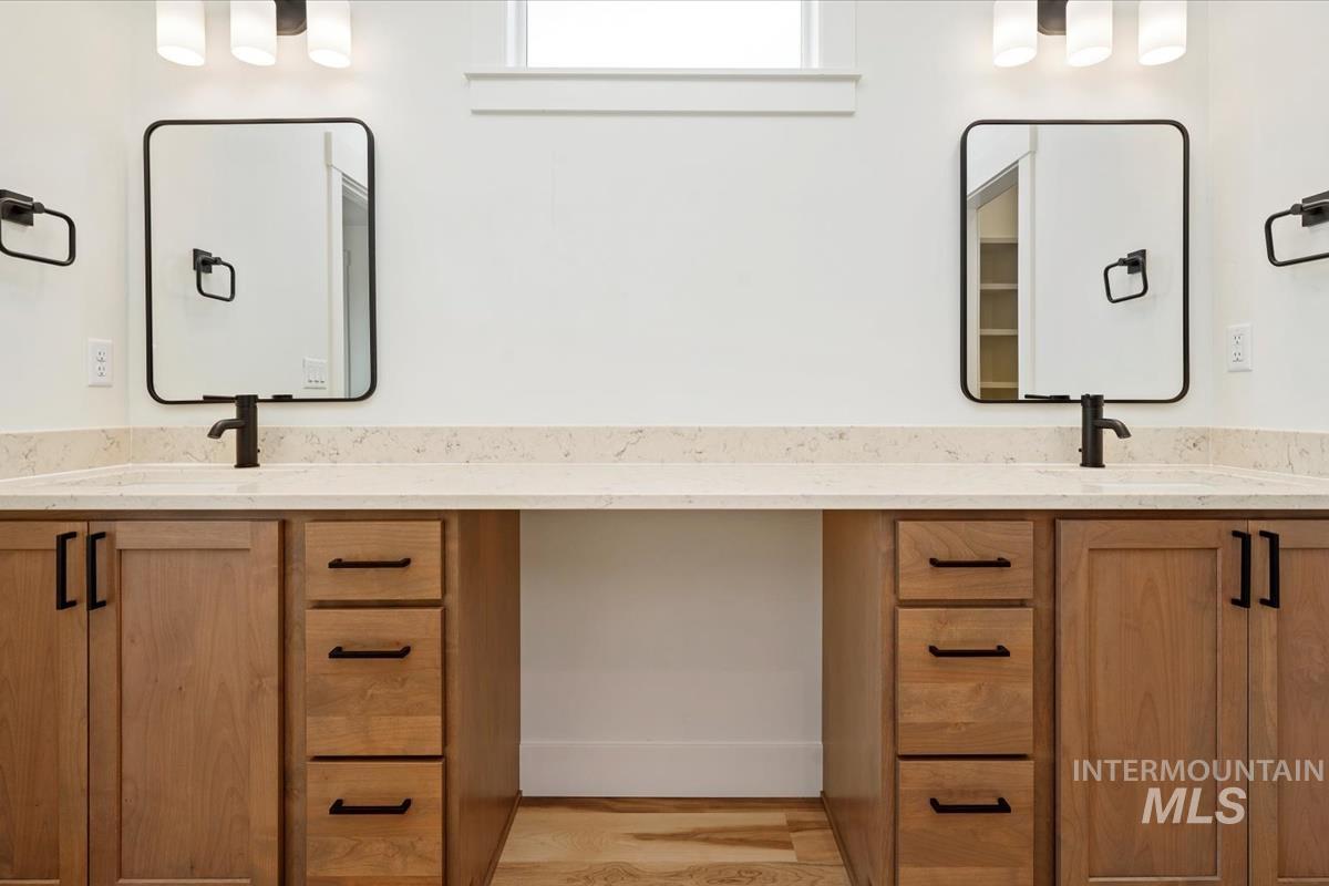 Full bath with vanity and wood finished floors