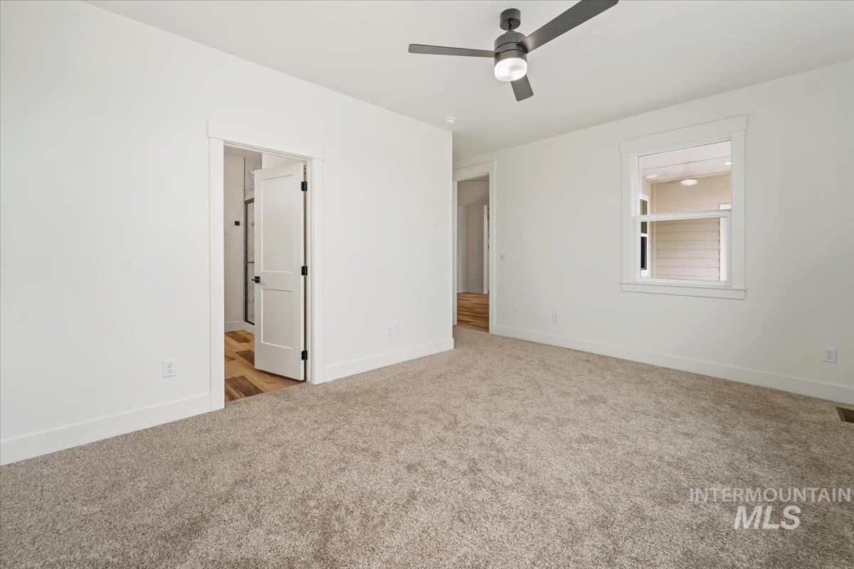 Unfurnished bedroom featuring carpet floors and connected bathroom