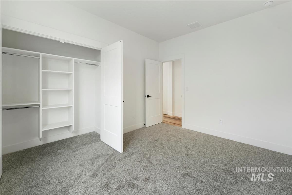 Unfurnished bedroom featuring carpet floors and a closet