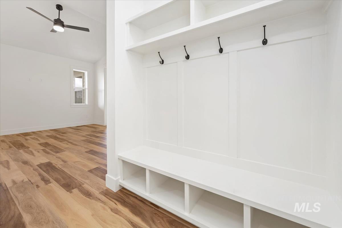 Mudroom featuring a ceiling fan, wood finished floors, and lofted ceiling