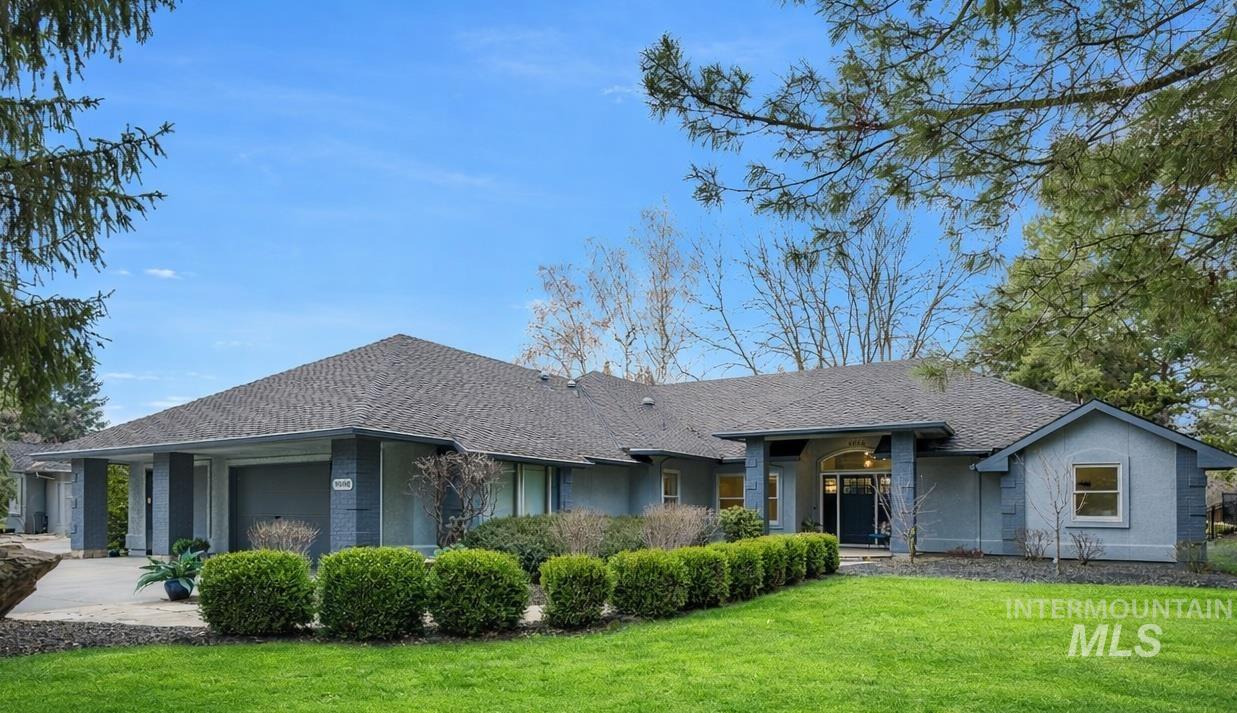 Ranch-style house with a front lawn and a garage