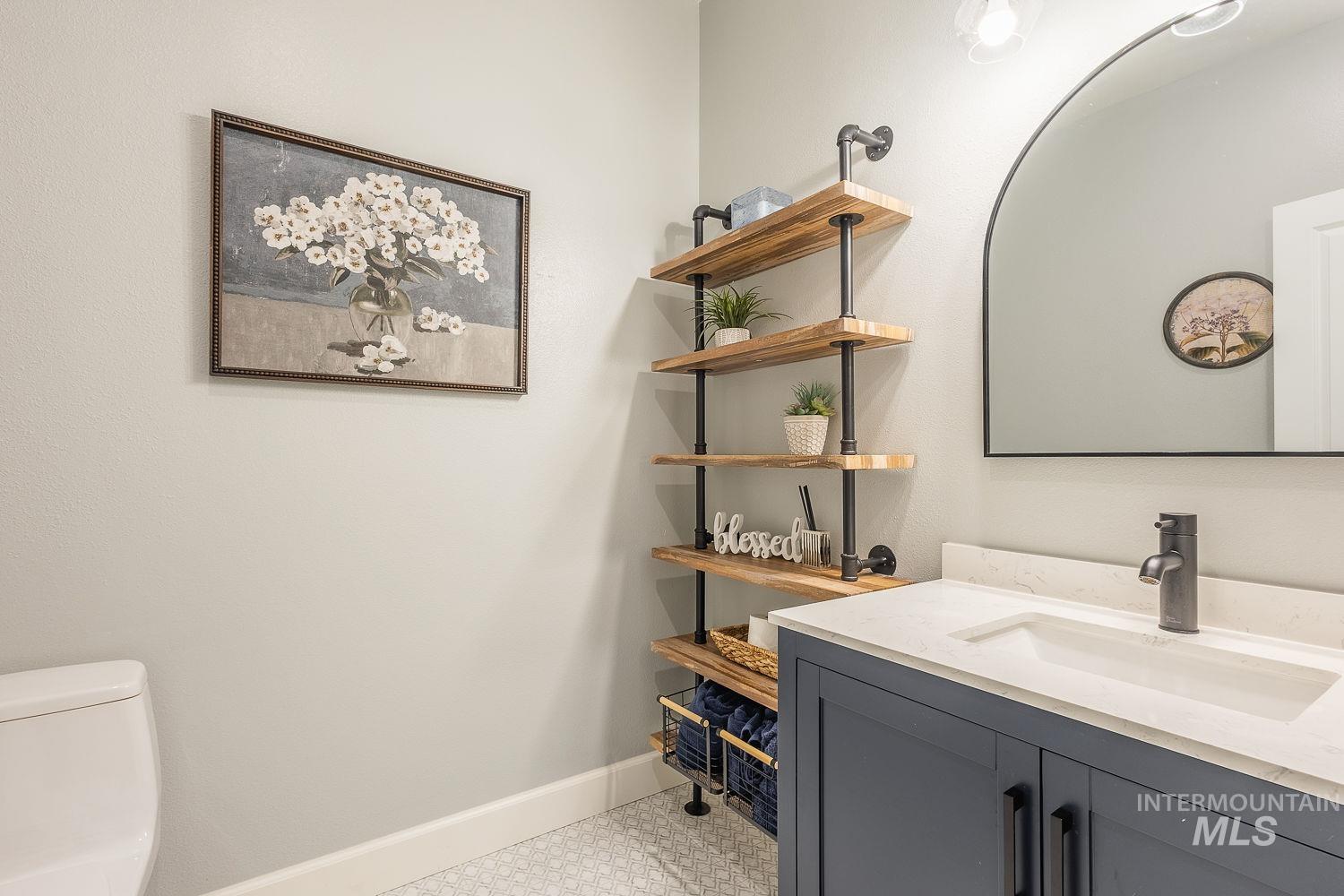 Half bath featuring vanity and toilet