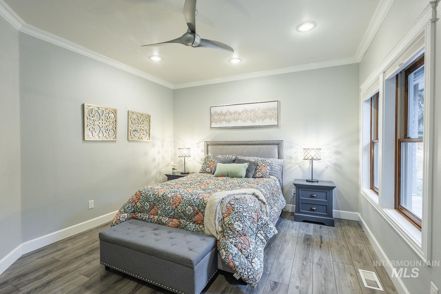 Bedroom featuring crown molding, wood finished floors, ceiling fan, and recessed lighting