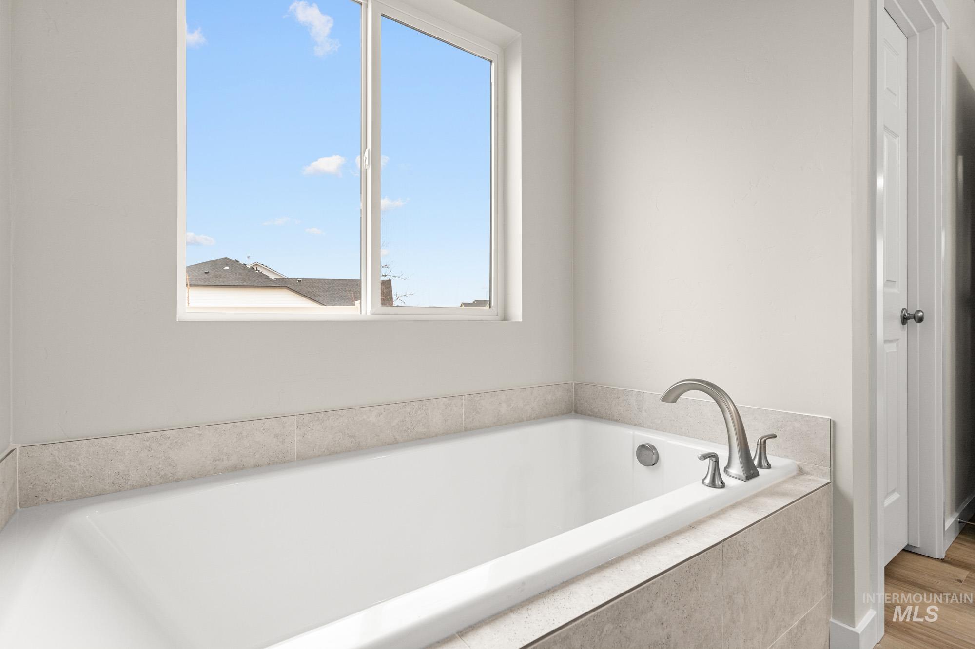 Full bathroom with a bath and healthy amount of natural light