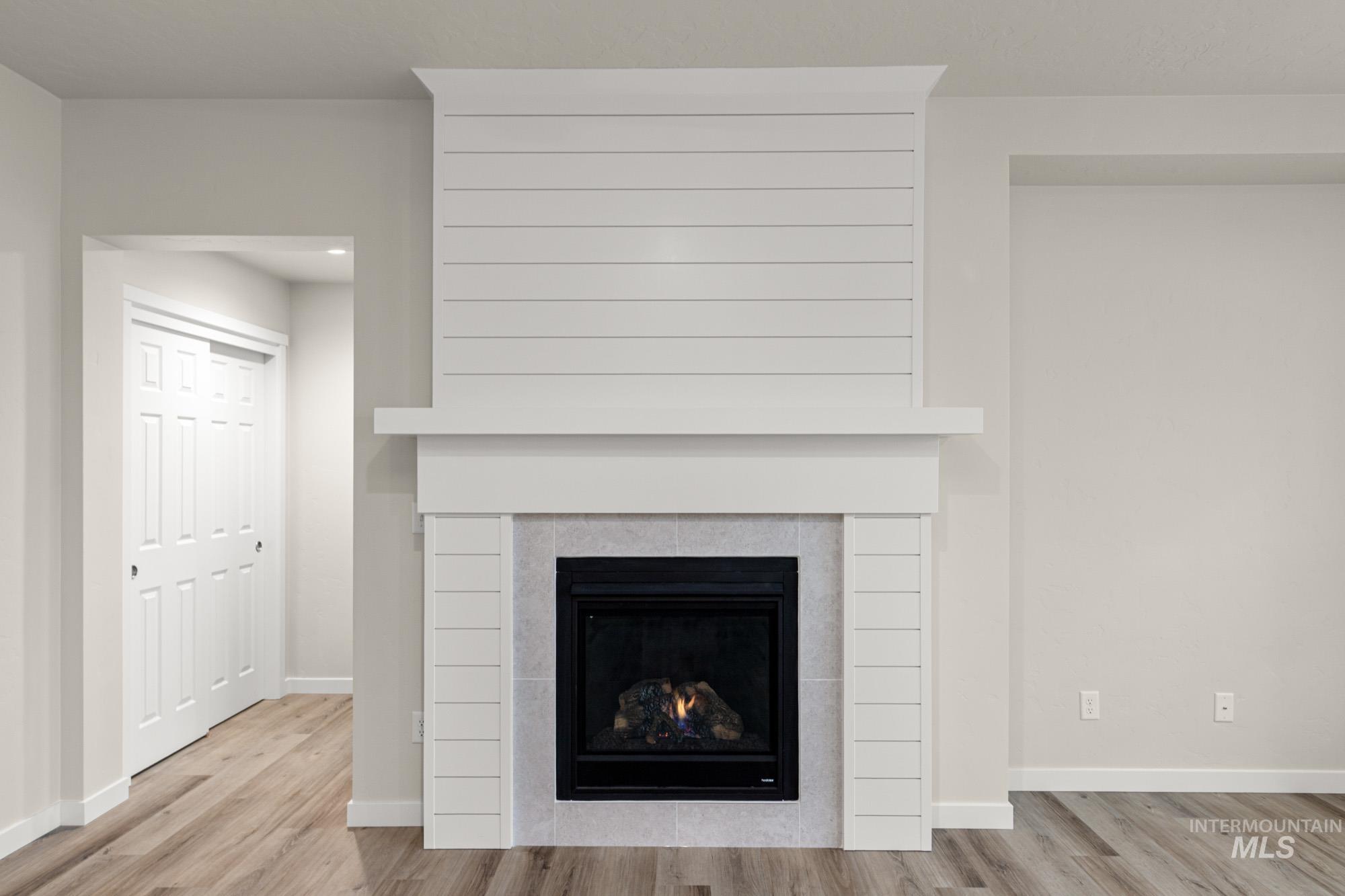 Detailed view of a tile fireplace and wood finished floors
