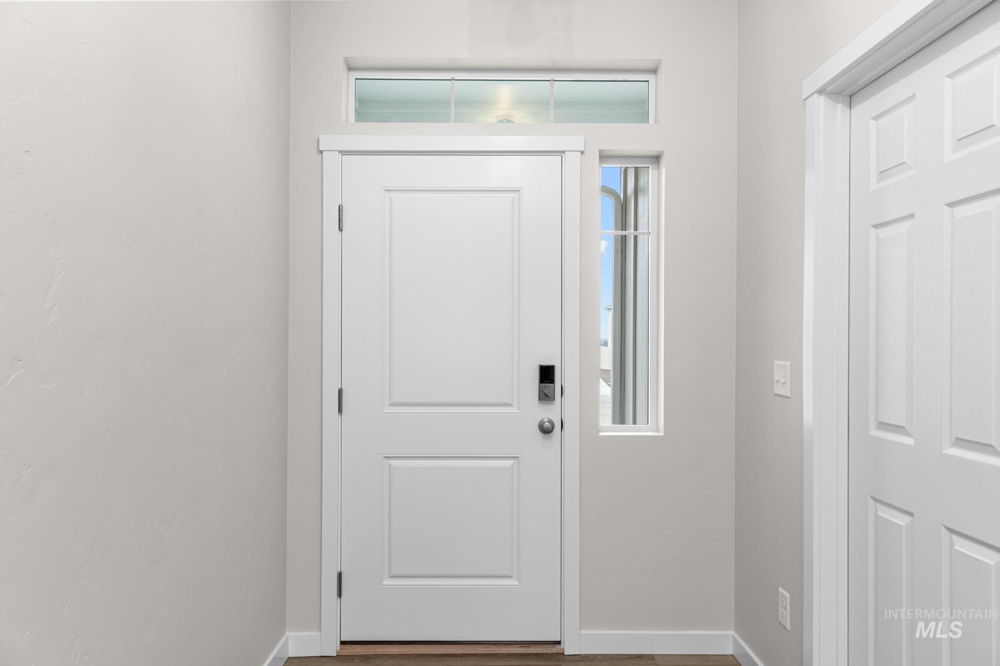 Foyer entrance with baseboards and wood finished floors