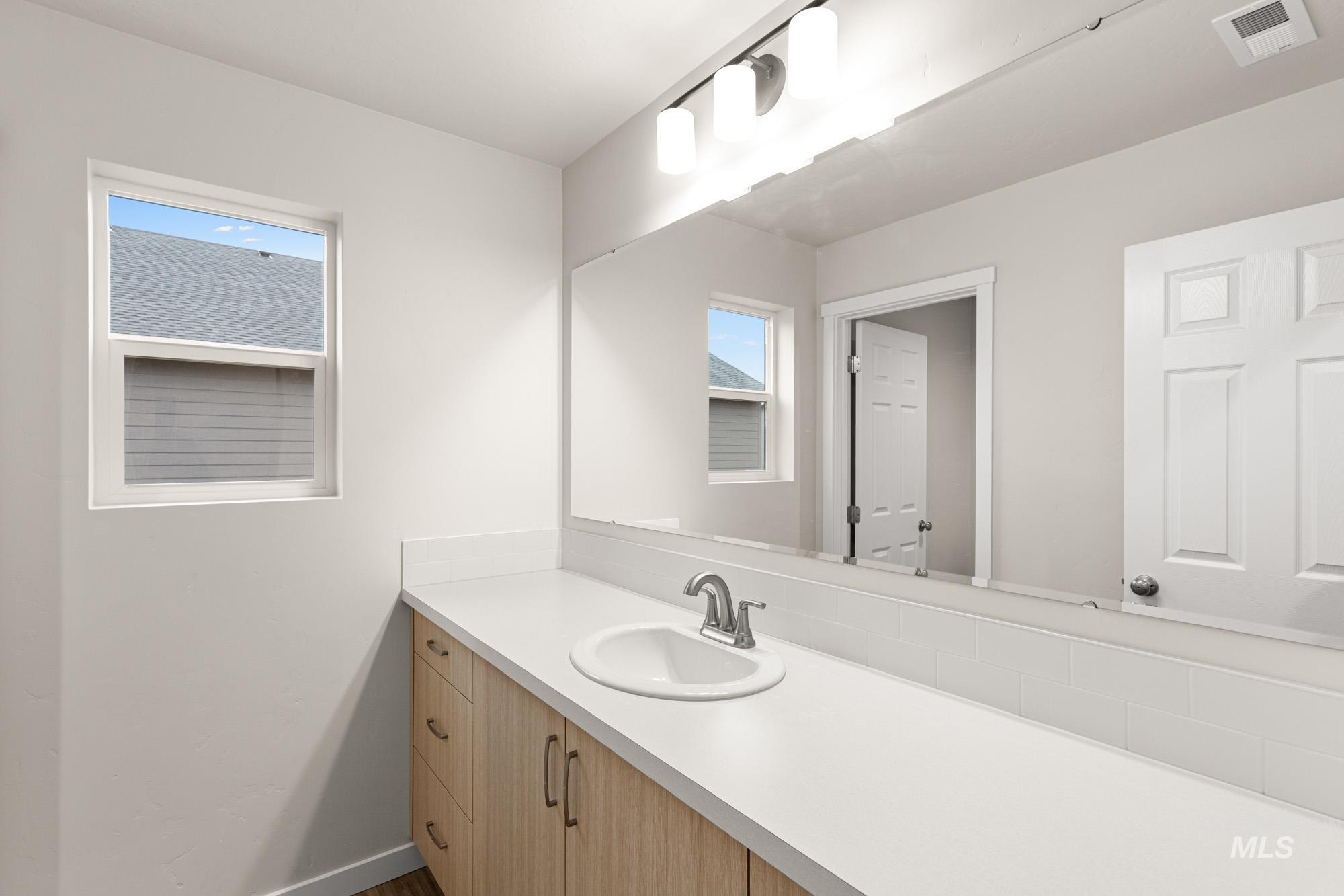 Bathroom with vanity and baseboards