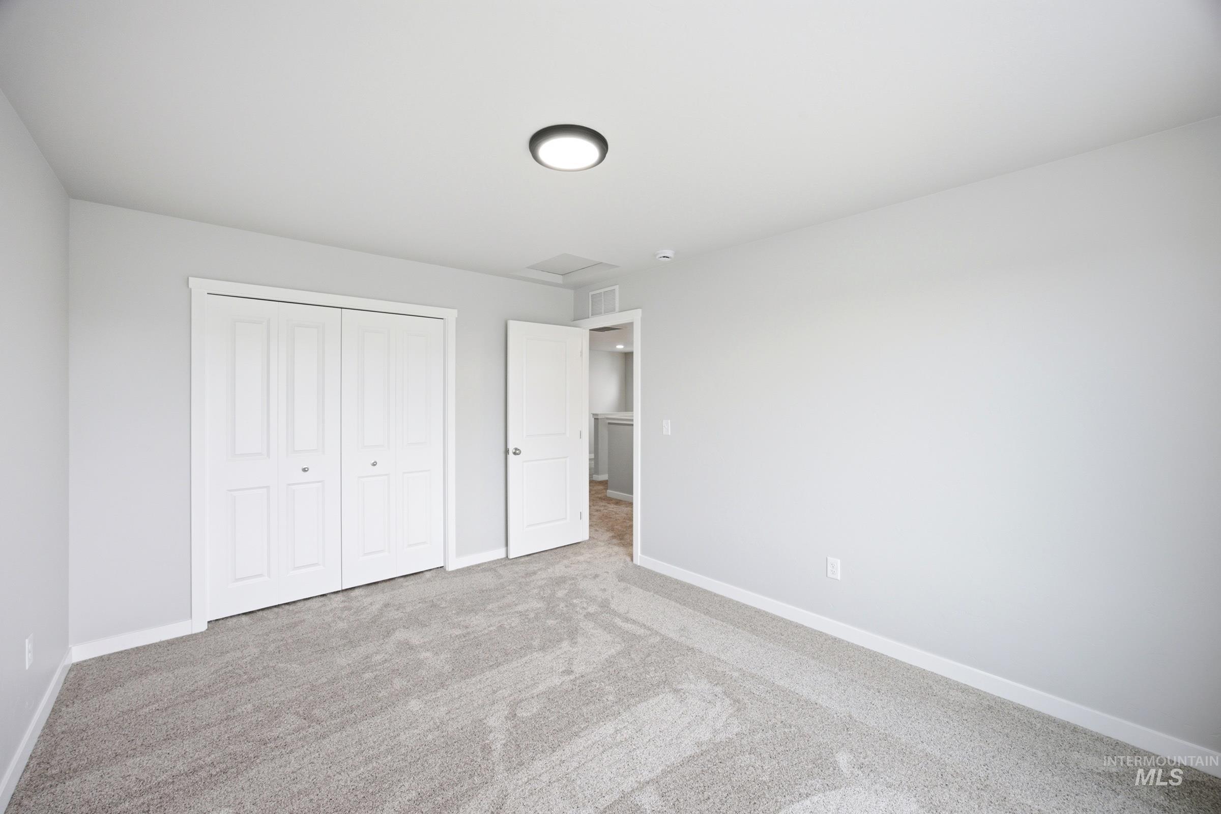 Gray wall-to-wall carpeting and neutral gray wall paint