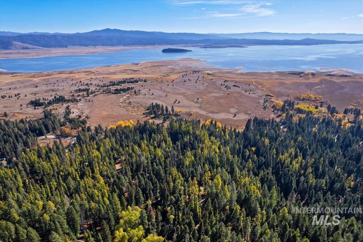 Aerial view of property and surrounding area with a water and mountain view
