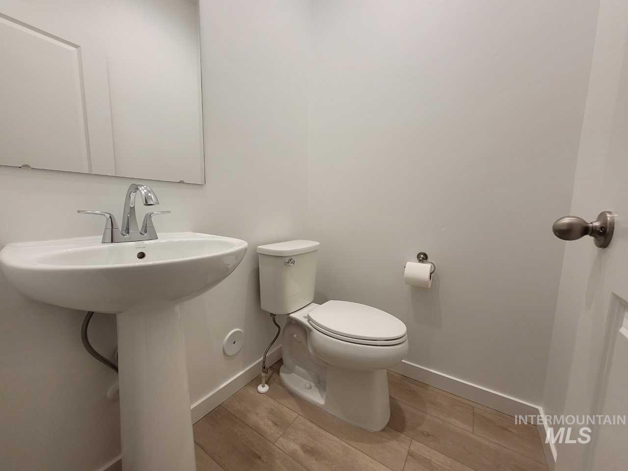 Bathroom featuring baseboards and light wood-style floors
