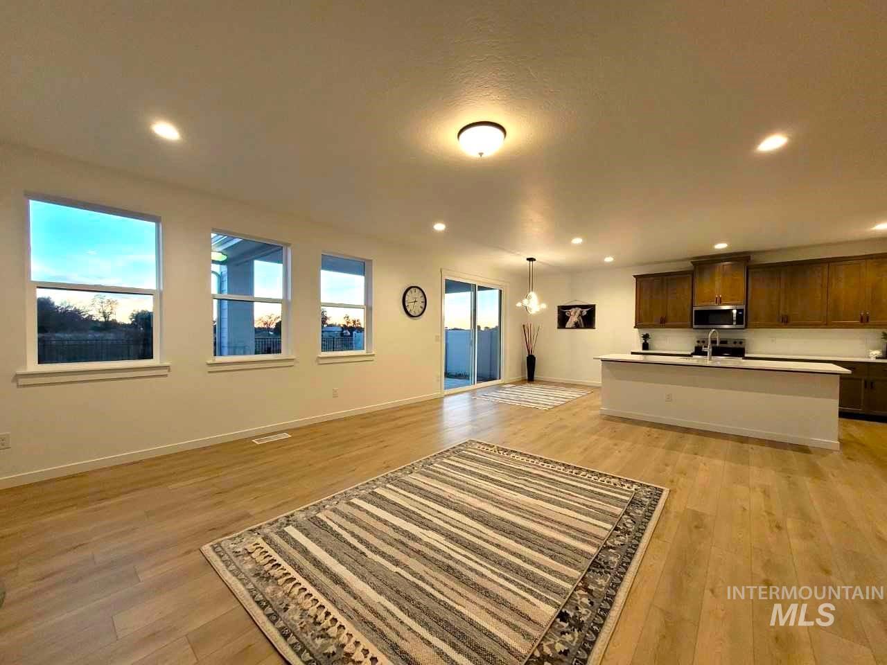 Living area featuring recessed lighting and light wood-style flooring