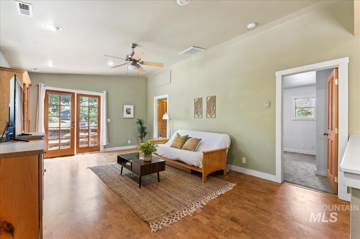 Living area featuring ceiling fan, wood finished floors, lofted ceiling, and recessed lighting