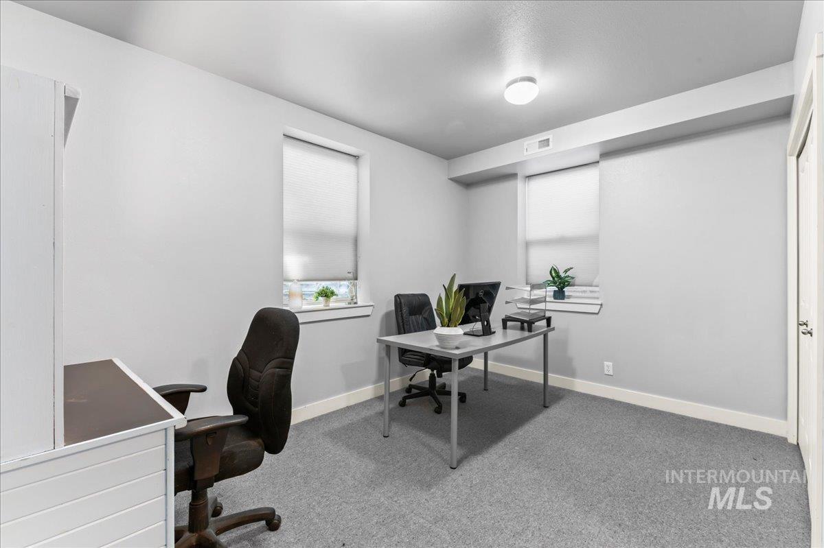 Carpeted office featuring baseboards