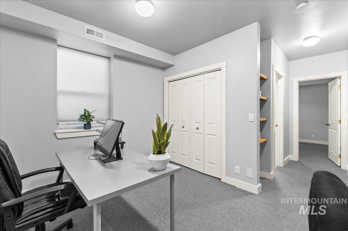 Carpeted office featuring baseboards