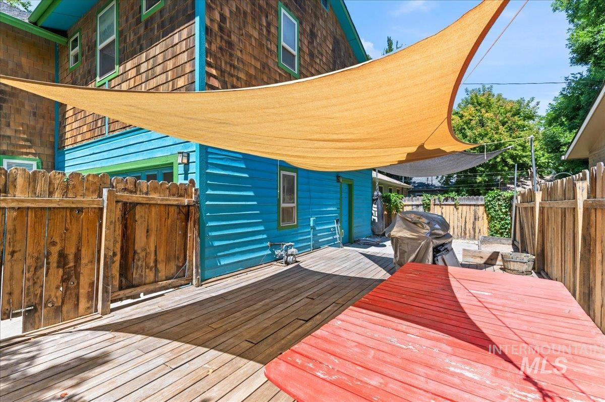 Wooden terrace featuring area for grilling