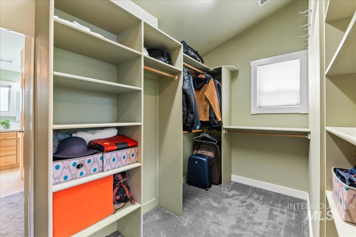 Walk in closet featuring carpet flooring and lofted ceiling