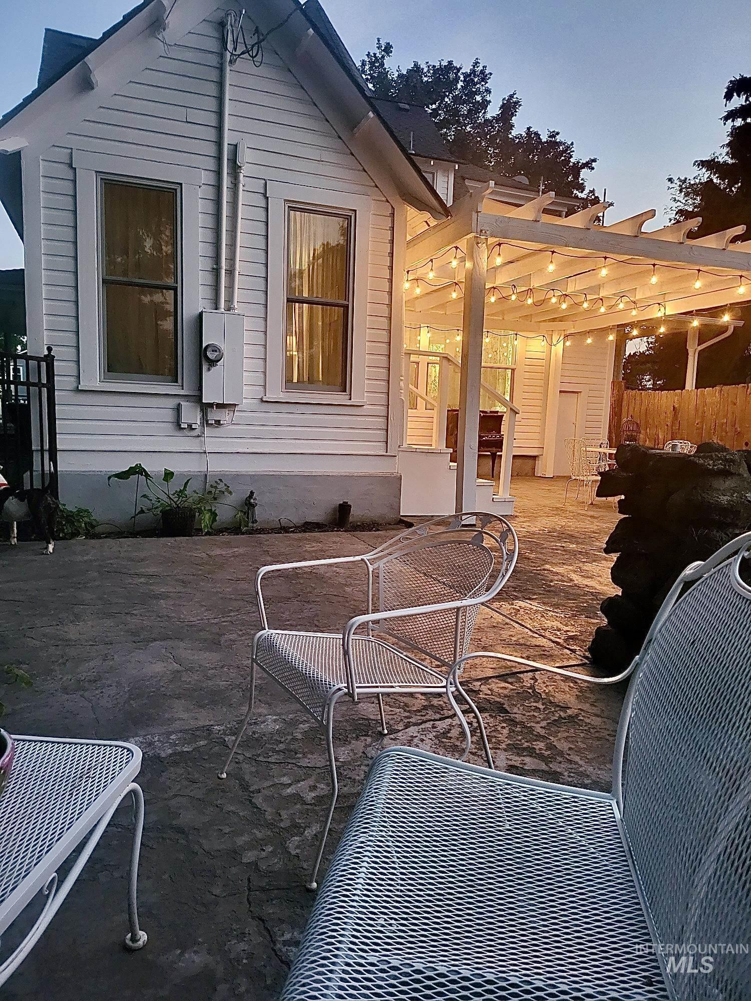 Rear view of property with a patio and a pergola