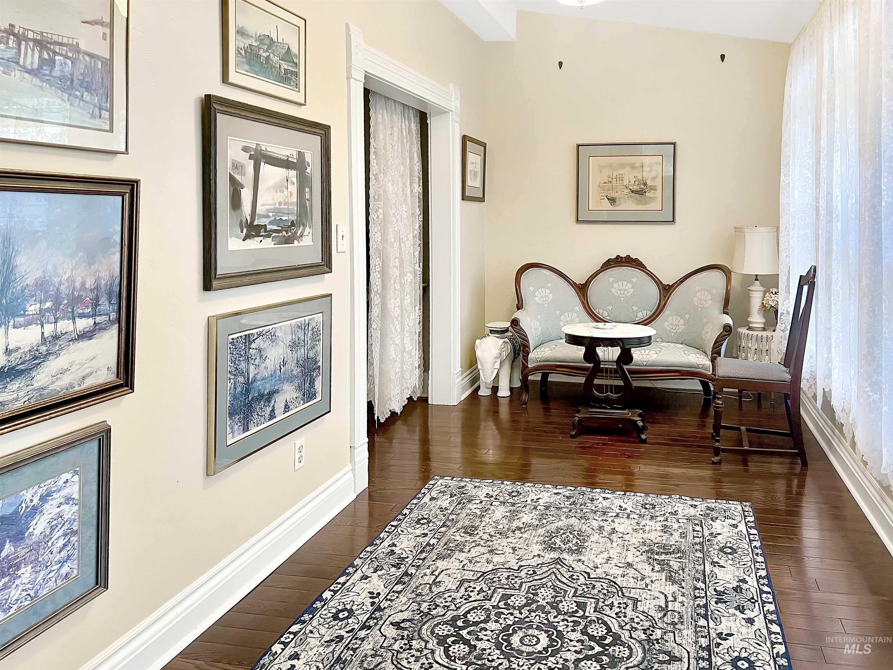 Living area with dark wood-style floors.