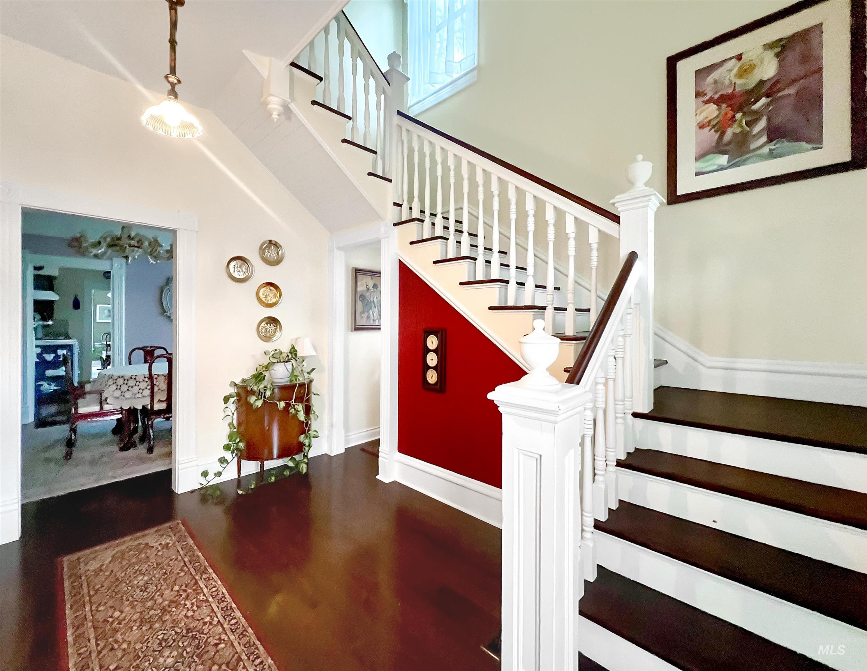 Stairway featuring a high ceiling and wood finished floors