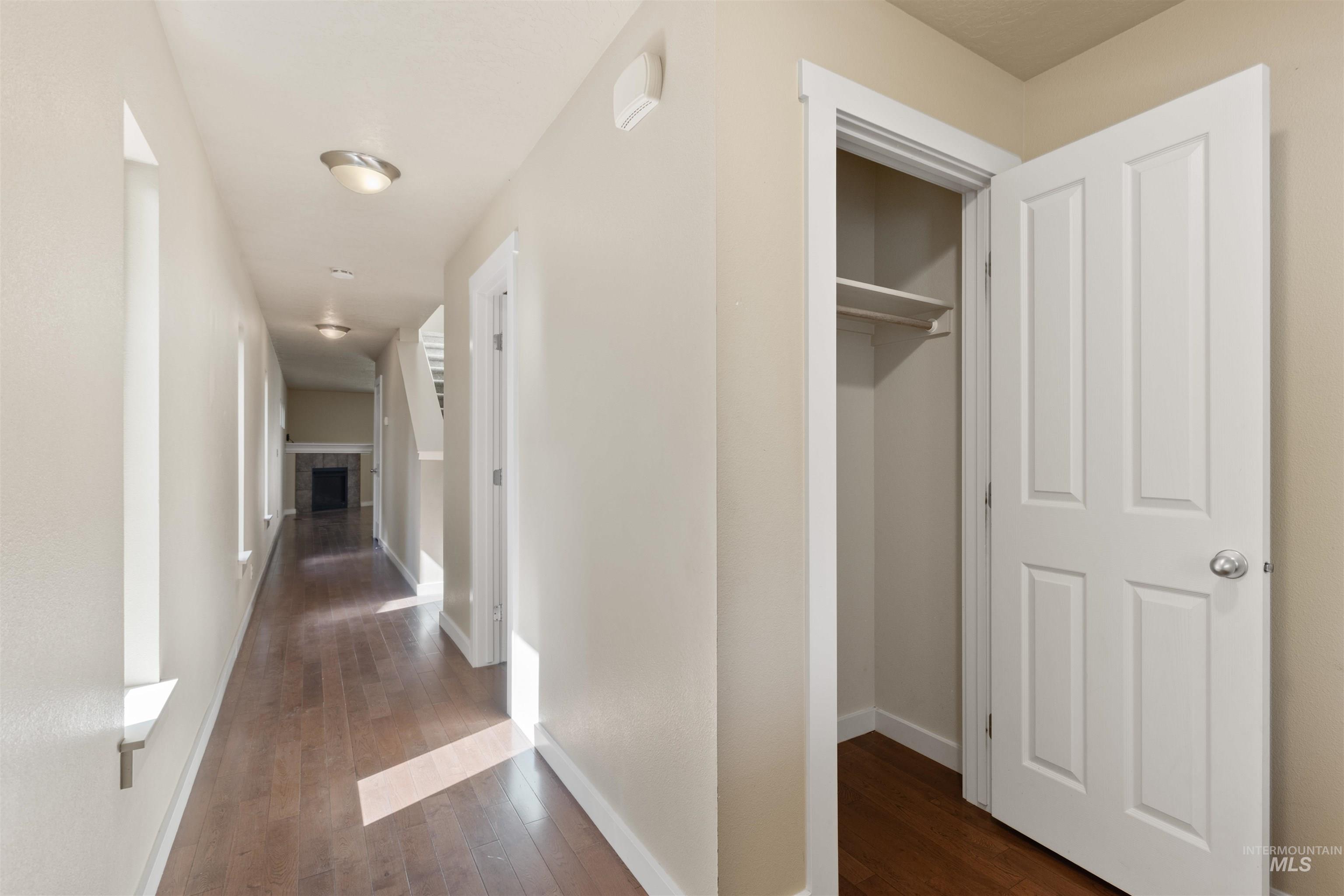 Hall featuring dark wood-style flooring