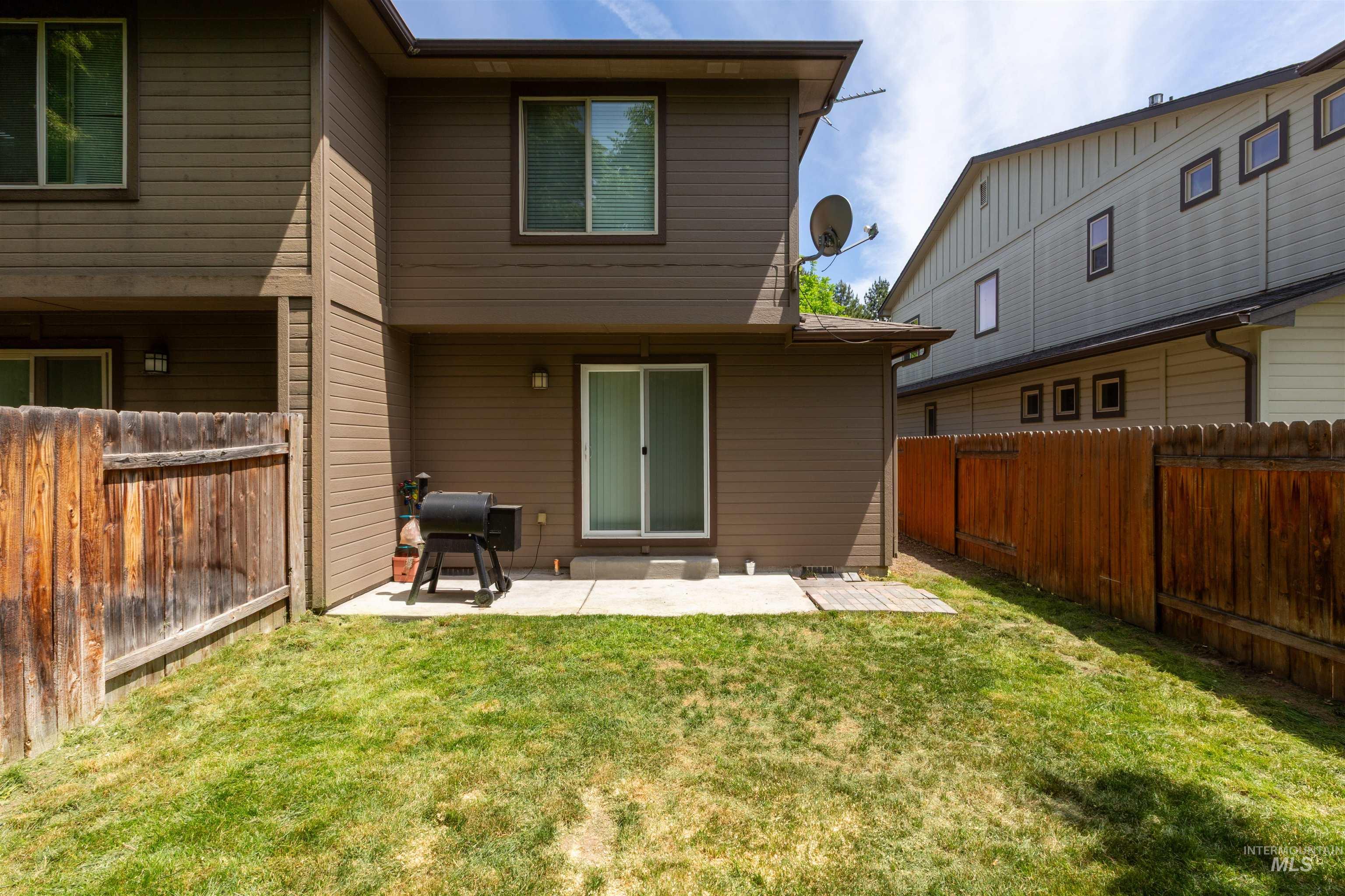 Back of house with a patio area and a fenced backyard