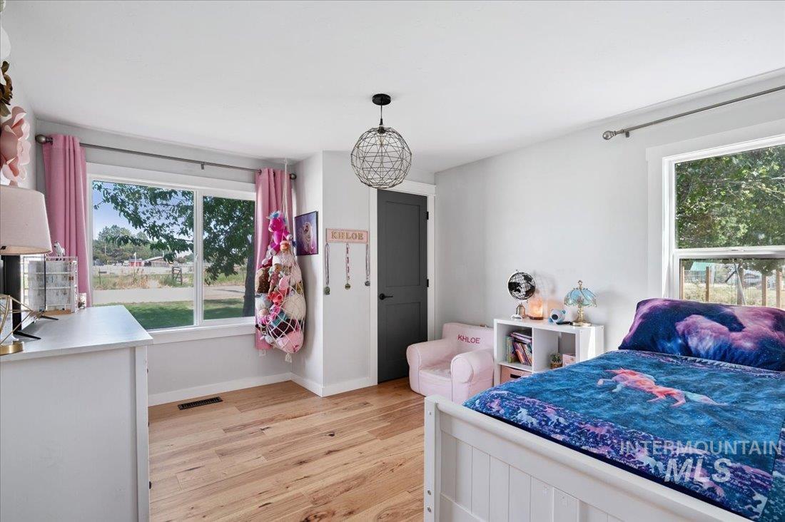 Bedroom featuring light wood-style floors and baseboards