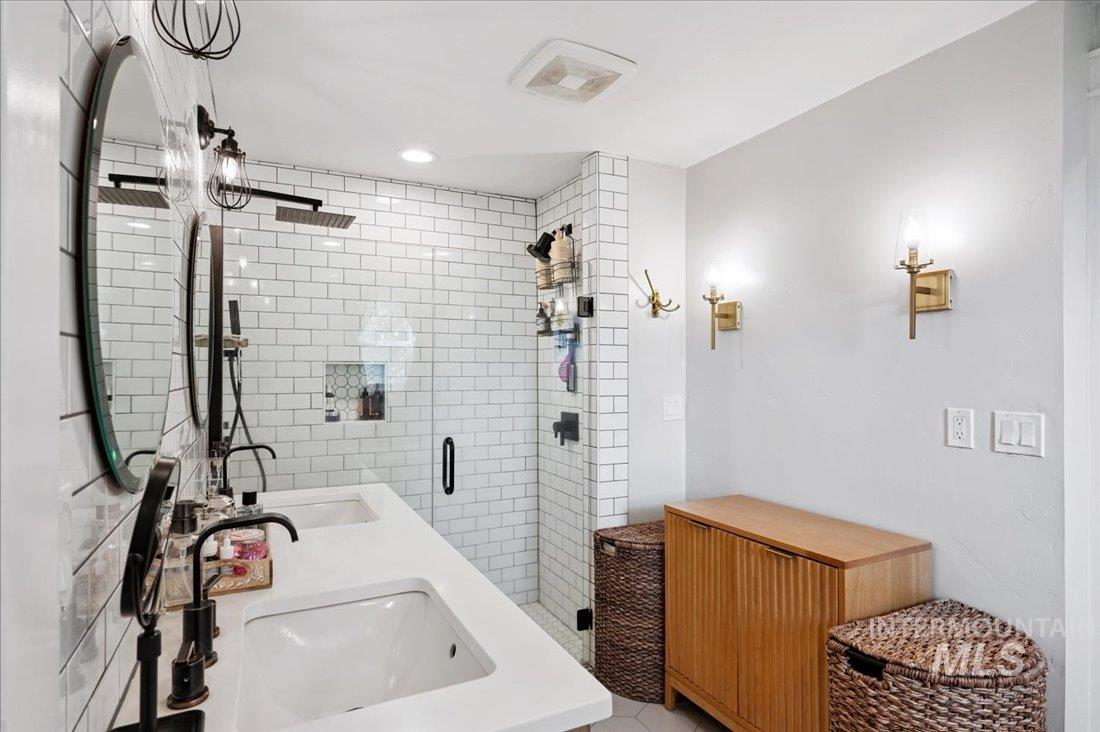 Bathroom with a shower stall and double vanity