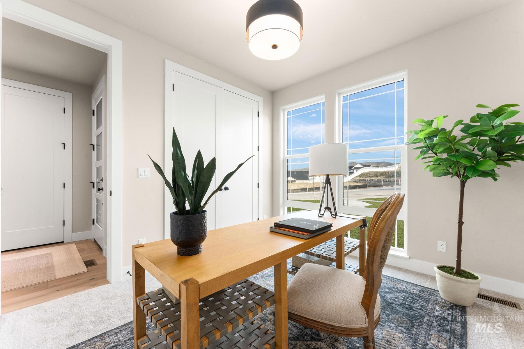 Office space featuring baseboards and light colored carpet