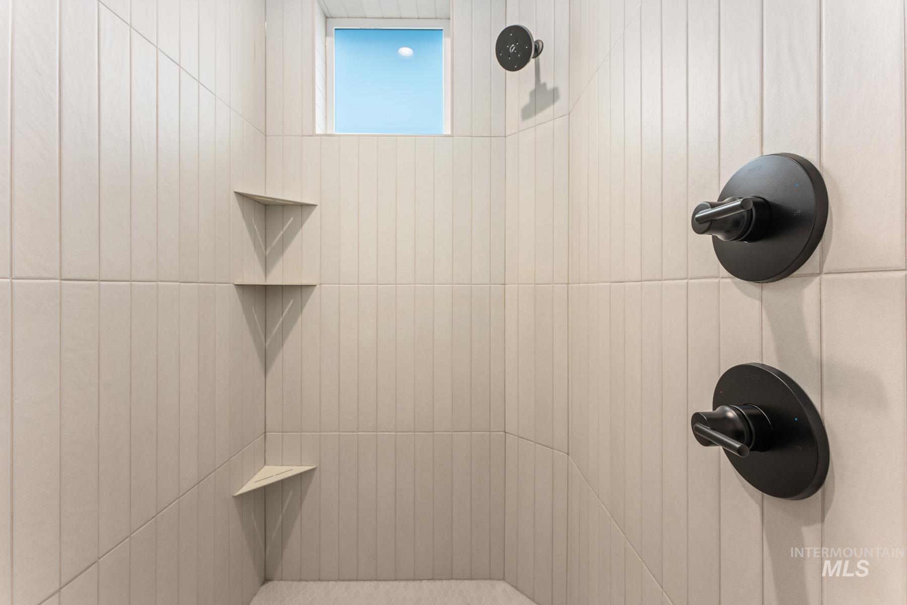 Bathroom view of a tile shower