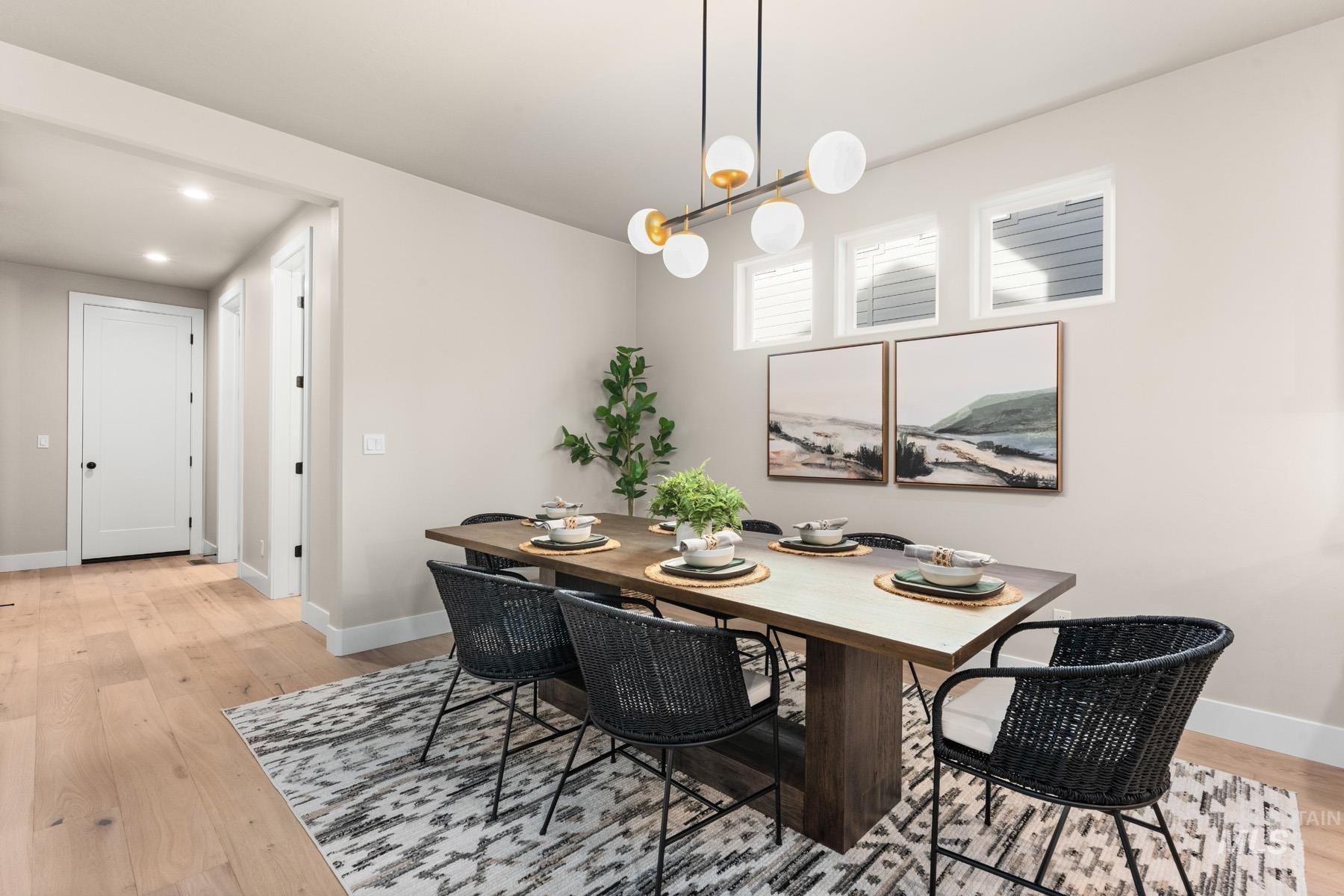 Dining space featuring light wood-style floors and suspended lighting