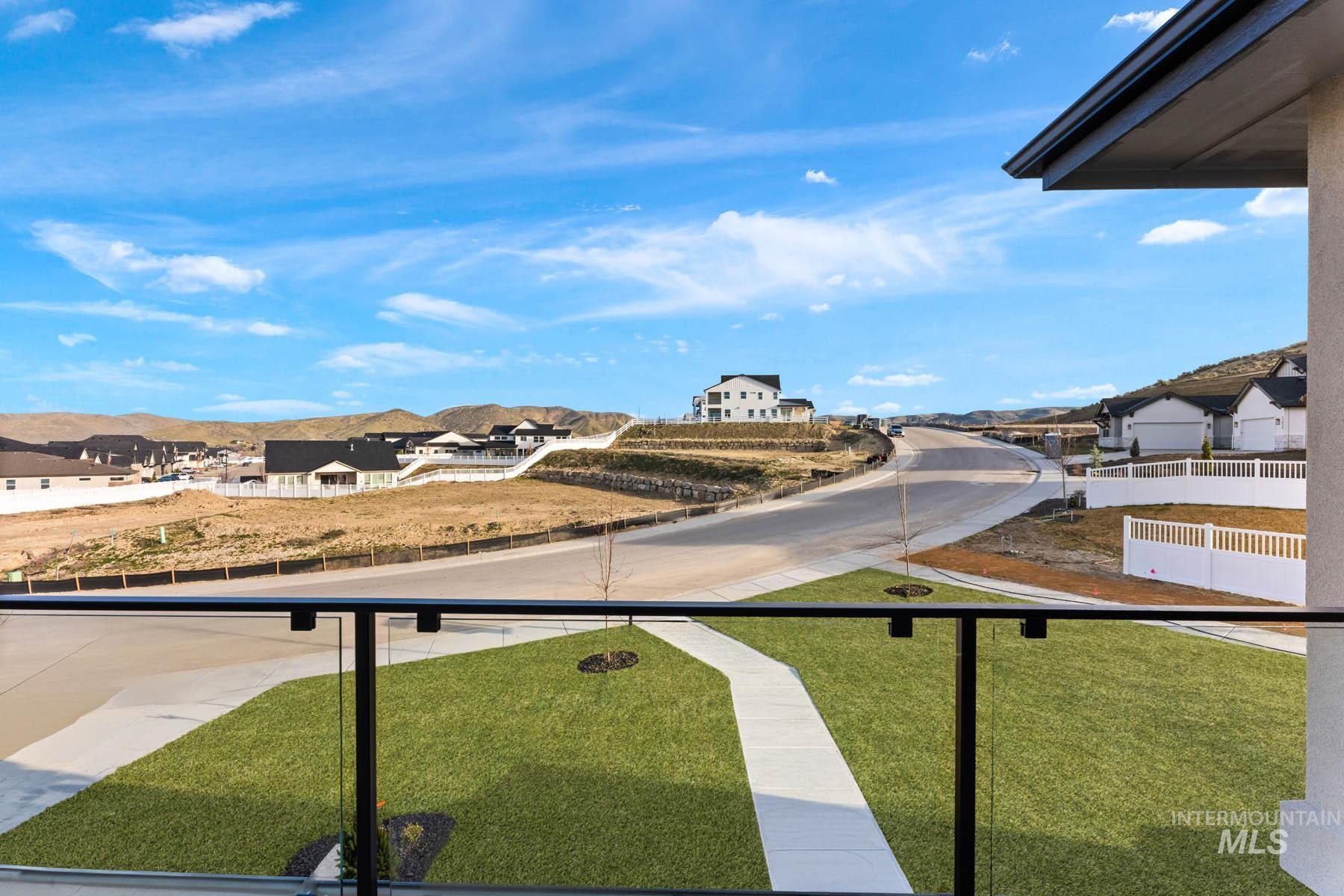 View of yard featuring a residential view and a balcony