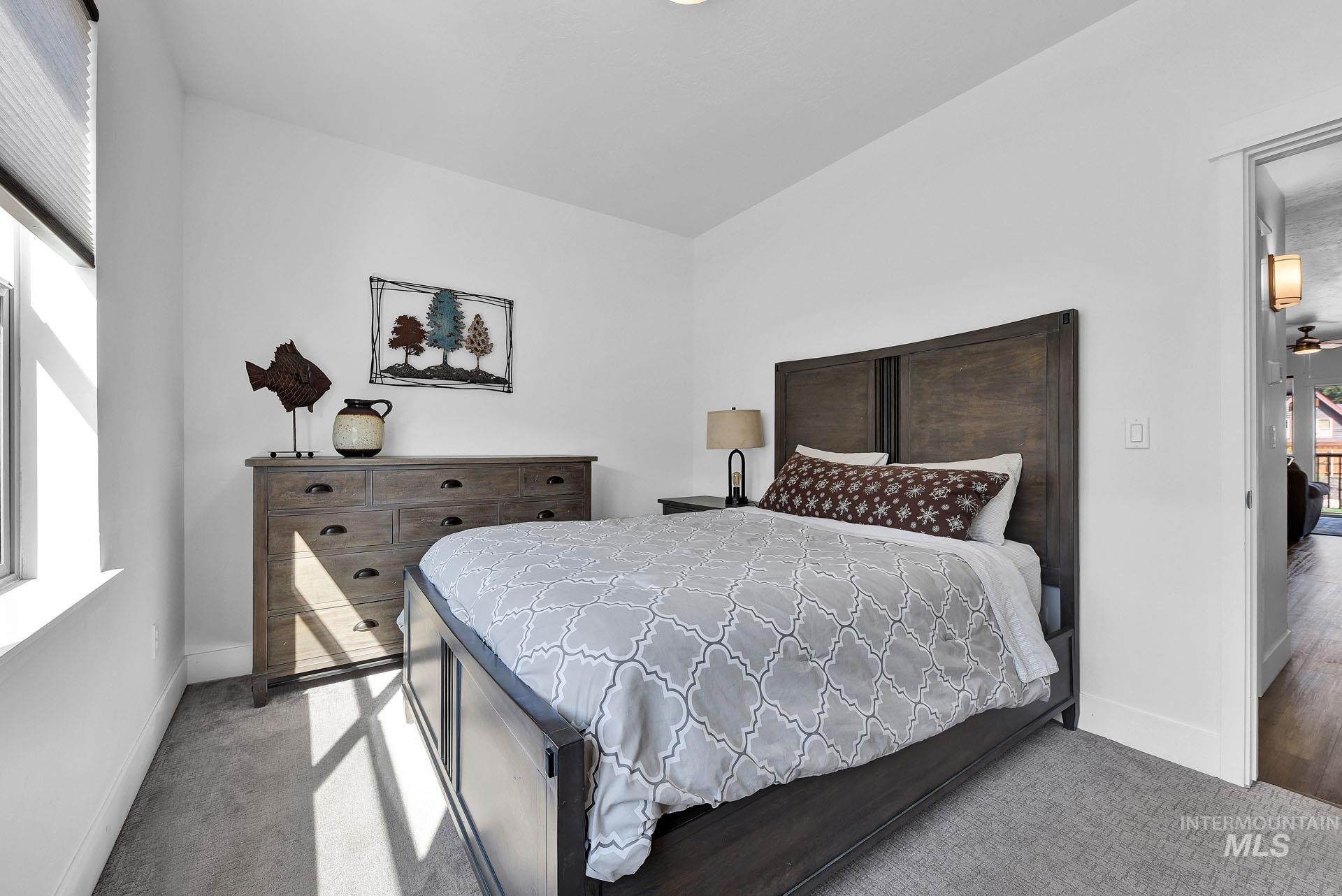 Bedroom featuring baseboards and light colored carpet