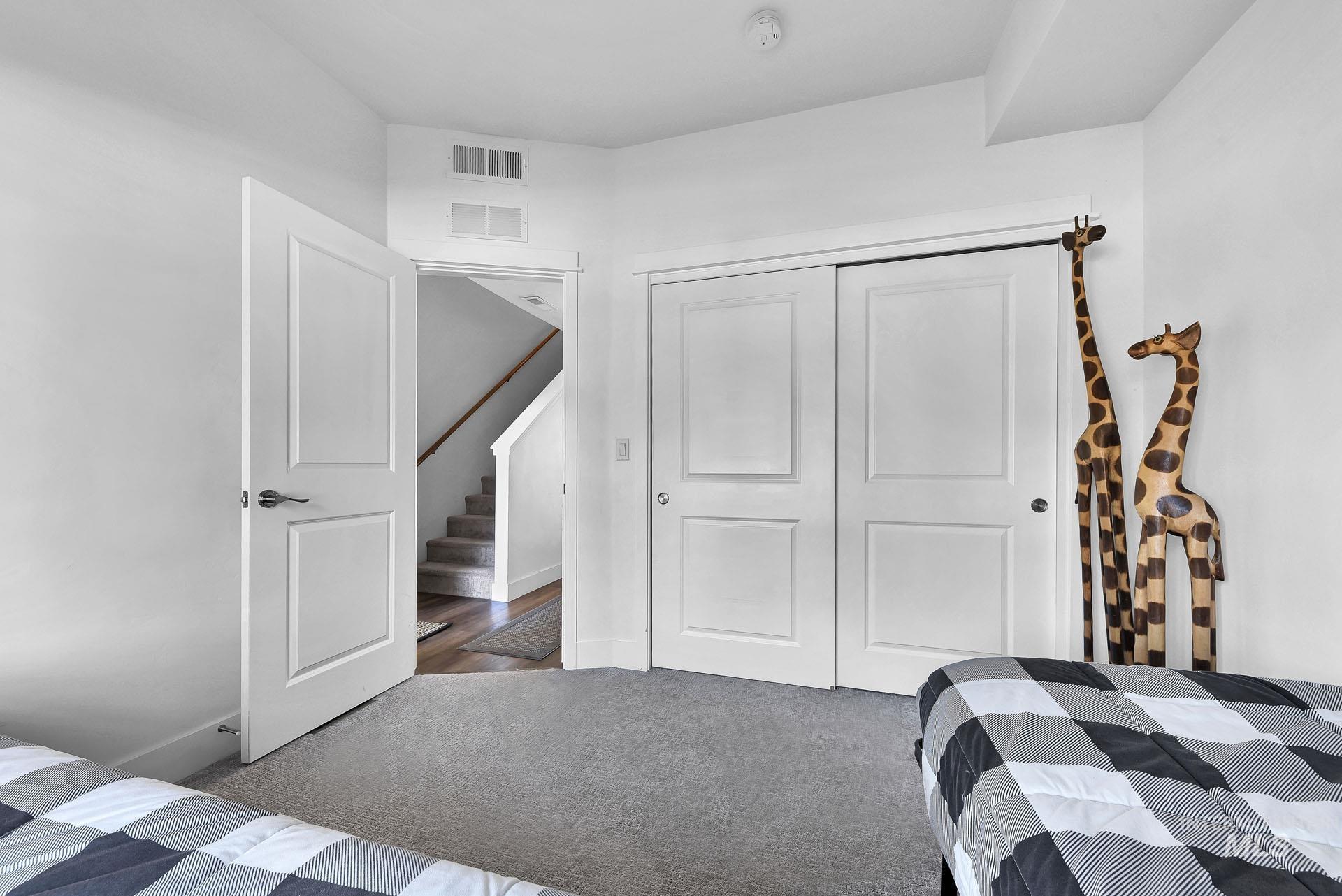 Carpeted bedroom featuring a closet and baseboards