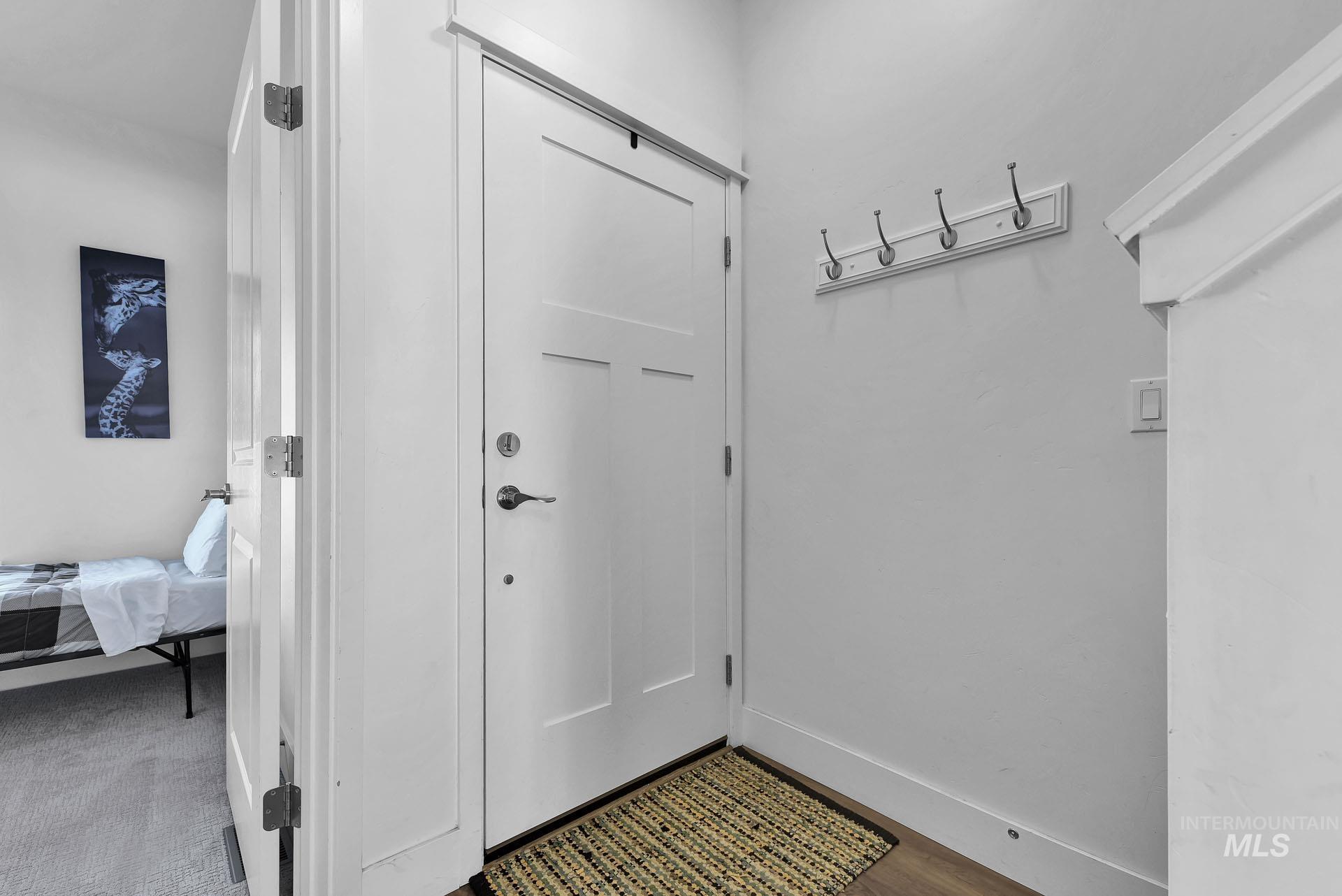 Doorway featuring baseboards