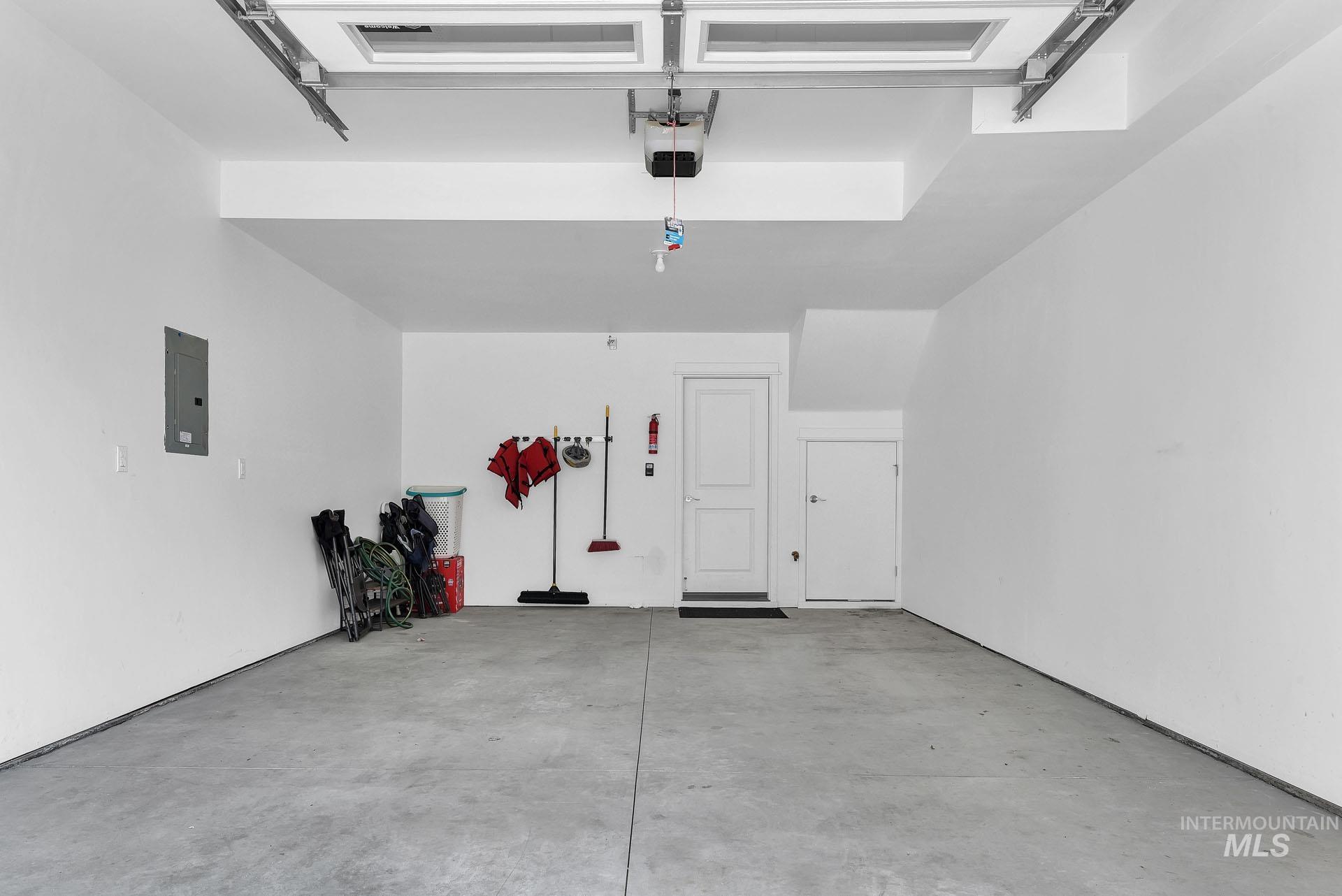 Garage with electric panel and a garage door opener
