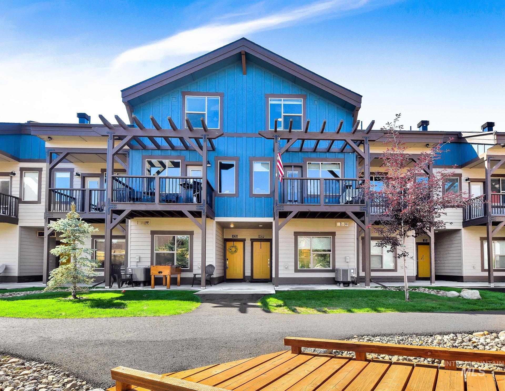 Back of property featuring a patio, board and batten siding, and a pergola