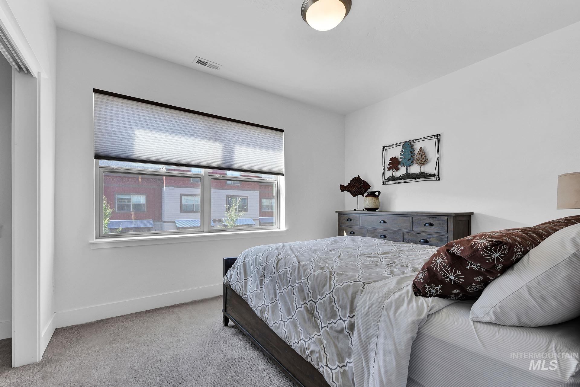 Bedroom featuring carpet flooring and baseboards