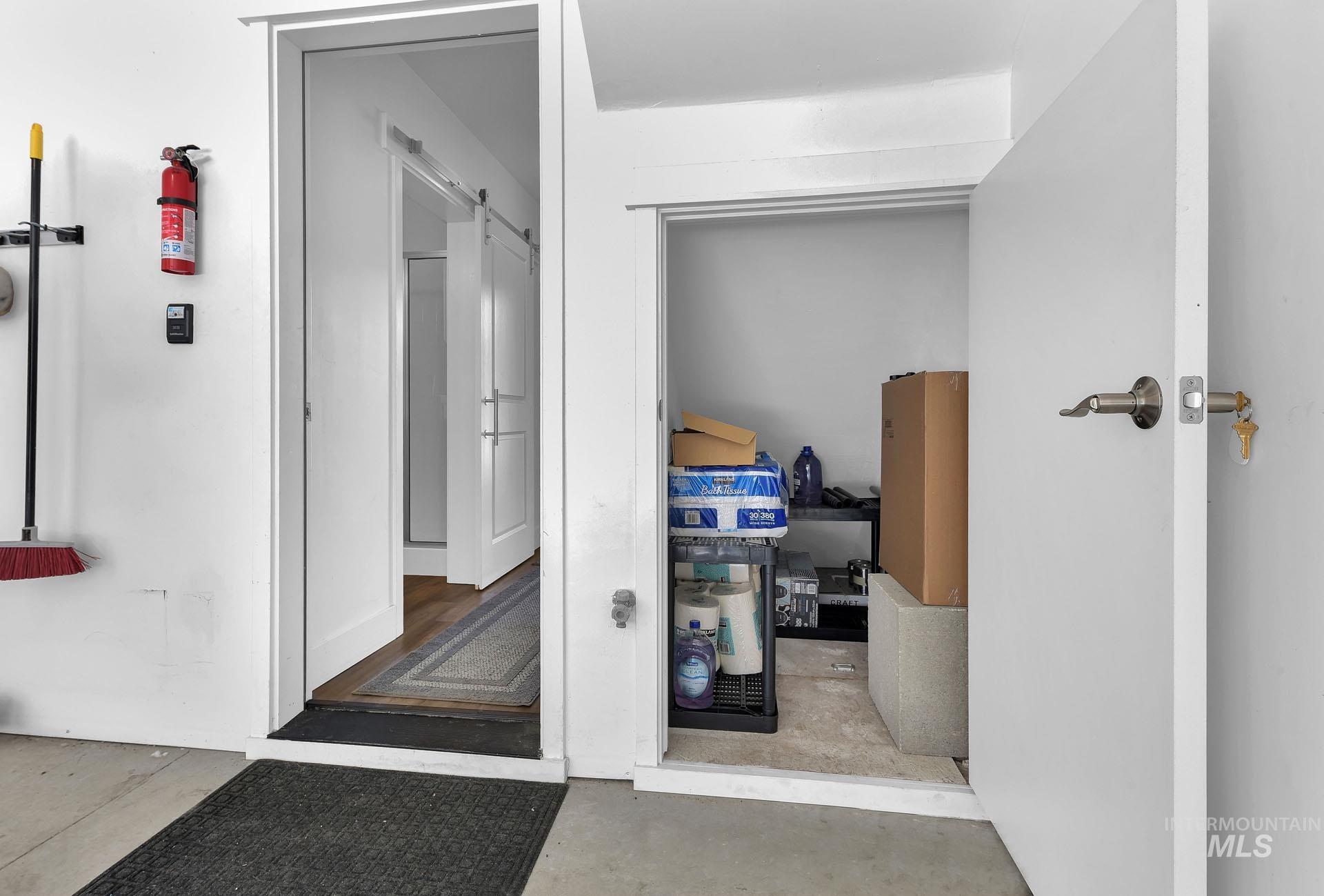 Corridor with a barn door and concrete flooring
