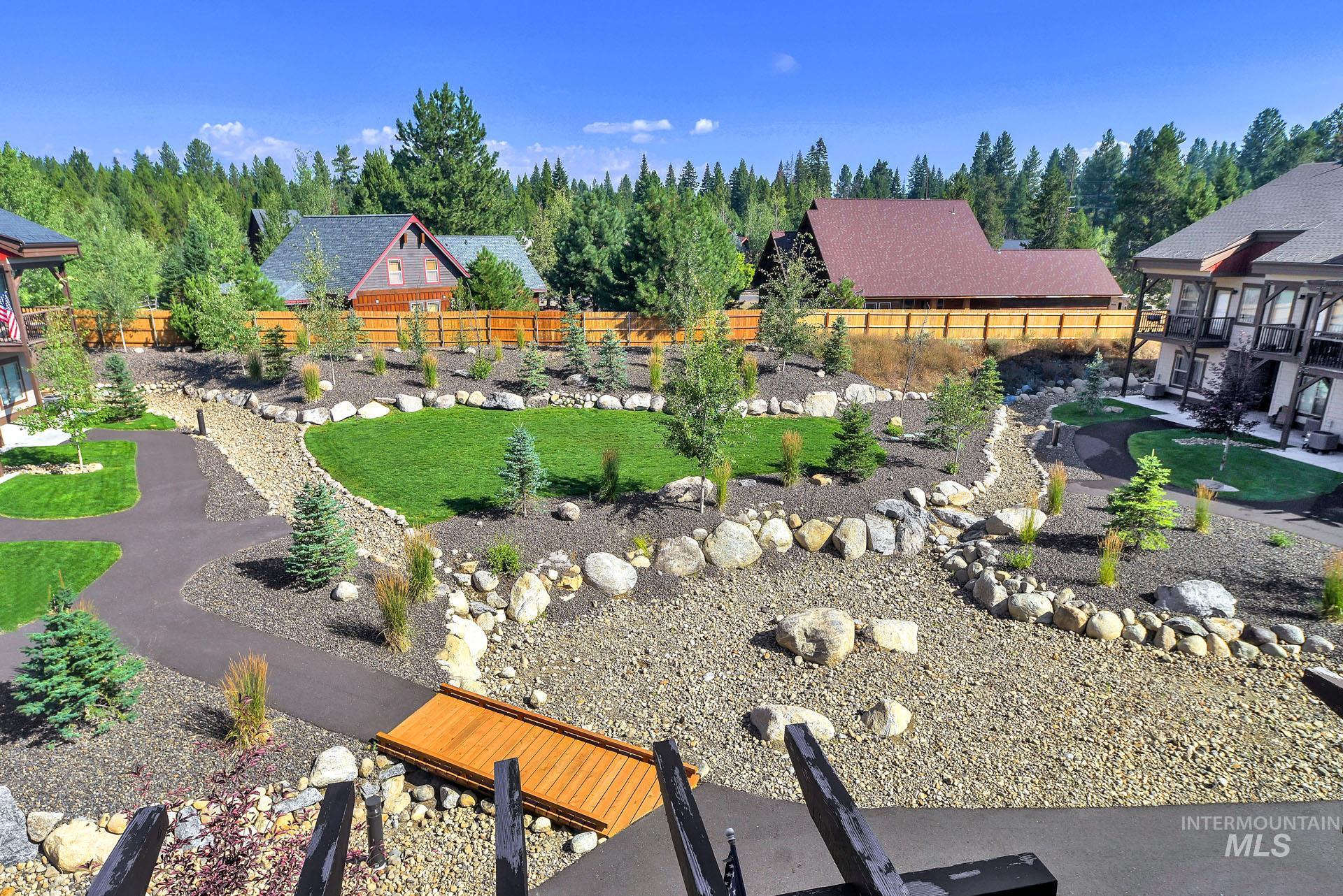 Fenced backyard with a patio area and an area to practice putting