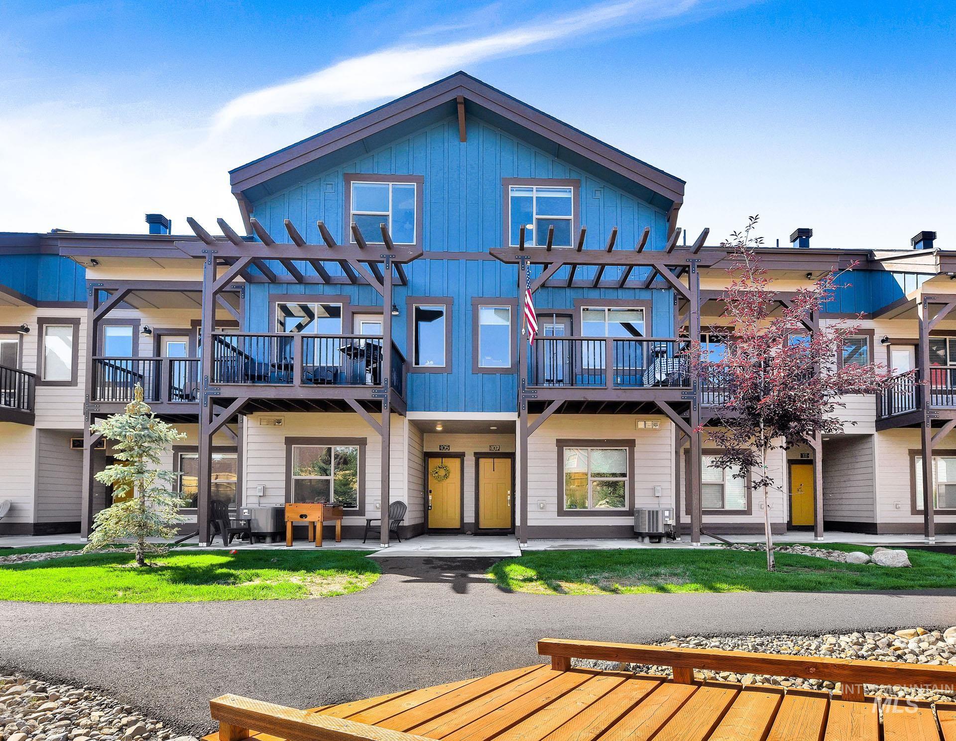 Back of property featuring a patio, board and batten siding, and a pergola