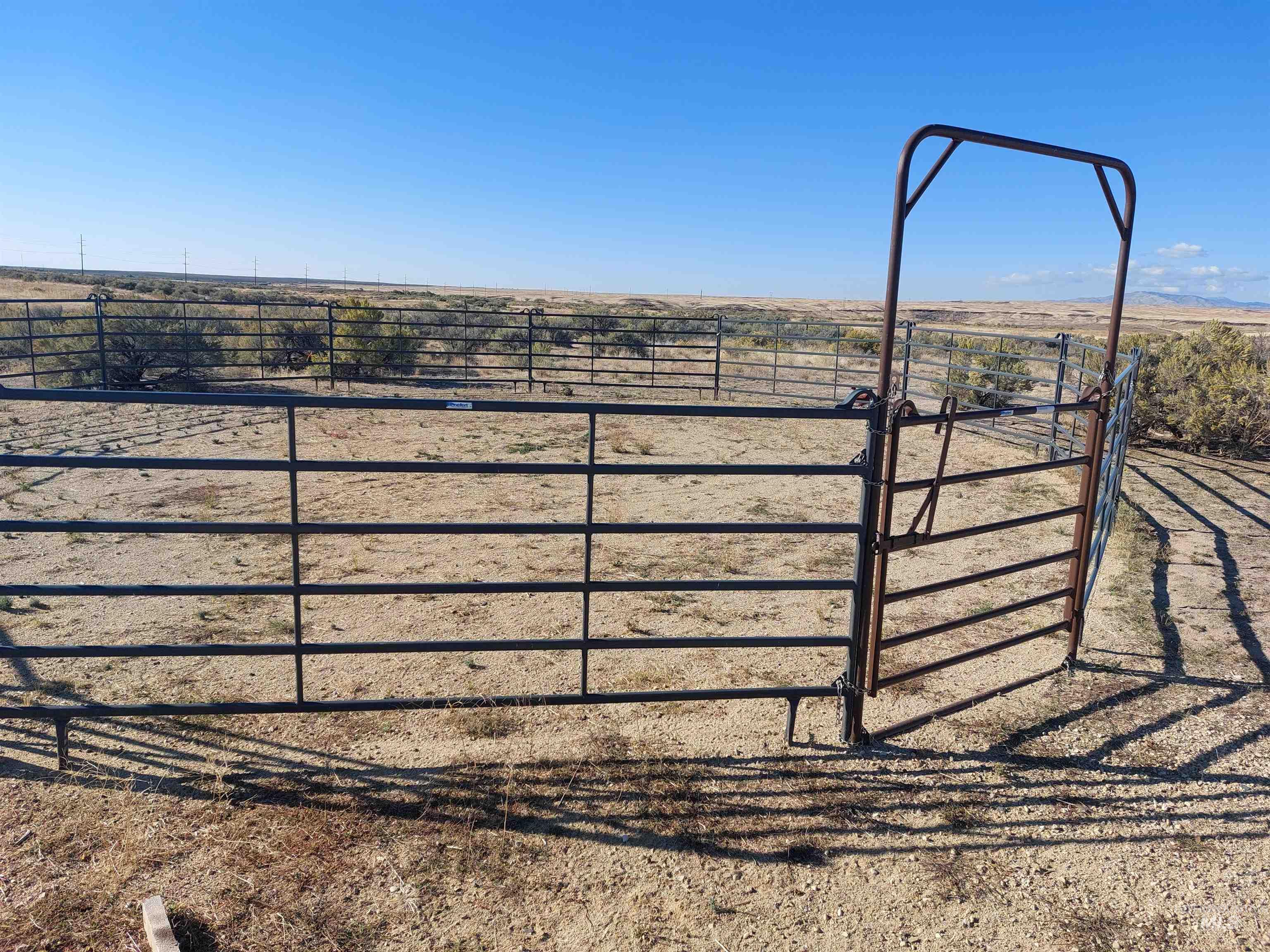 Gate with a rural view and an outbuilding
