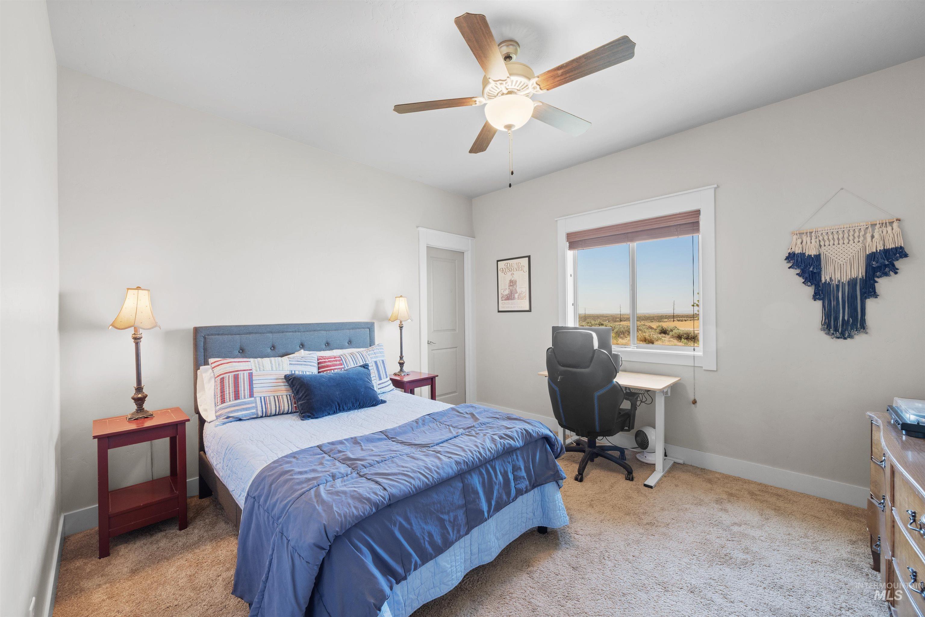 Bedroom with light carpet and ceiling fan